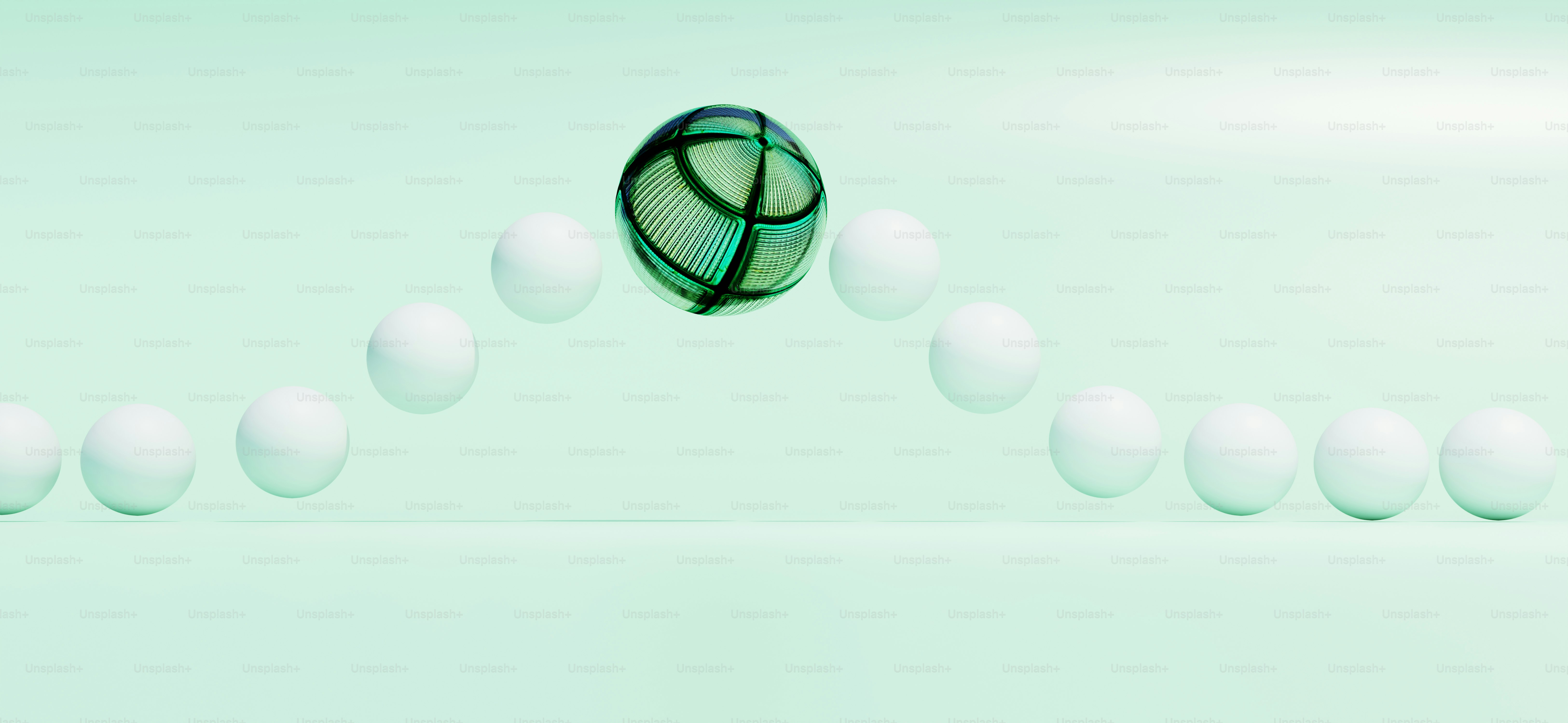 A green ball floats above white spheres.