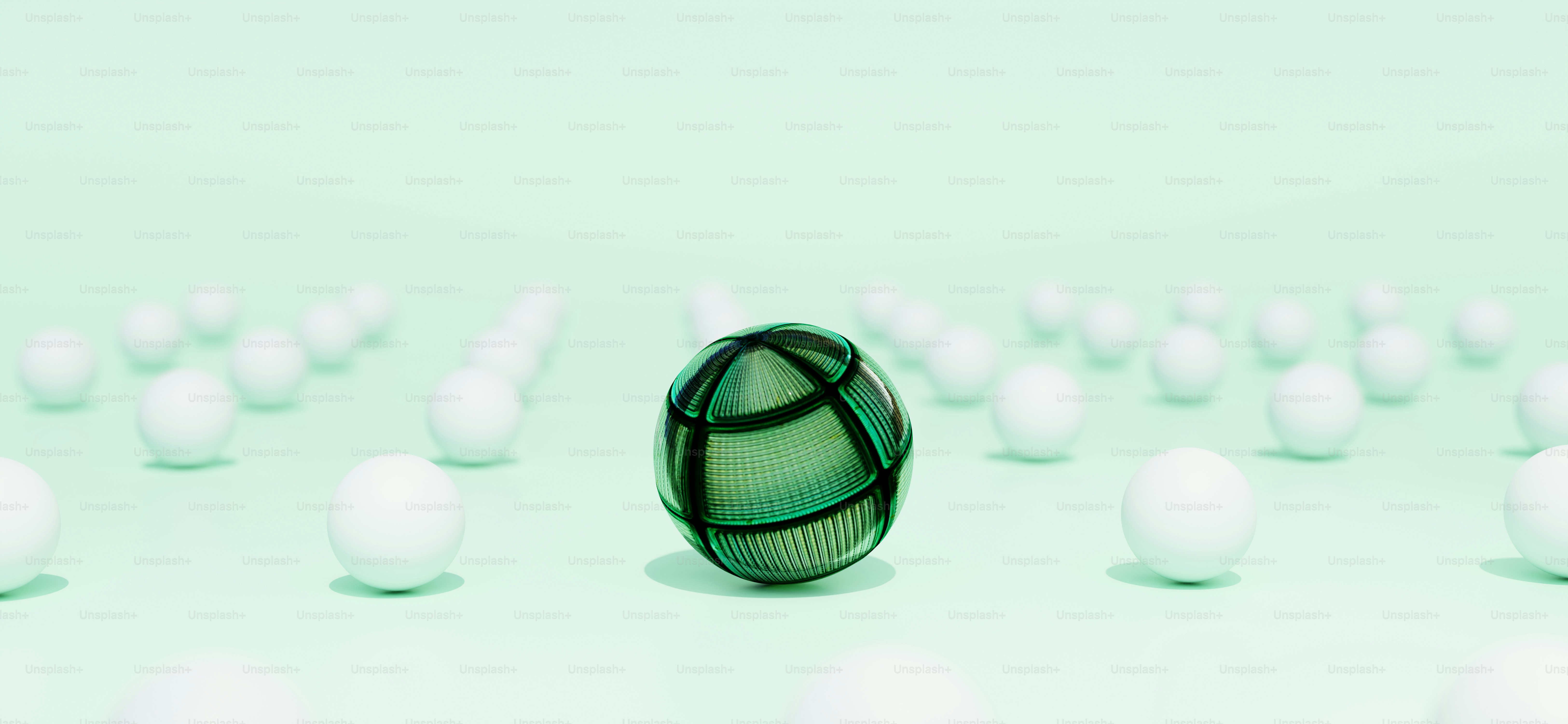 A green, patterned sphere stands out amongst others.