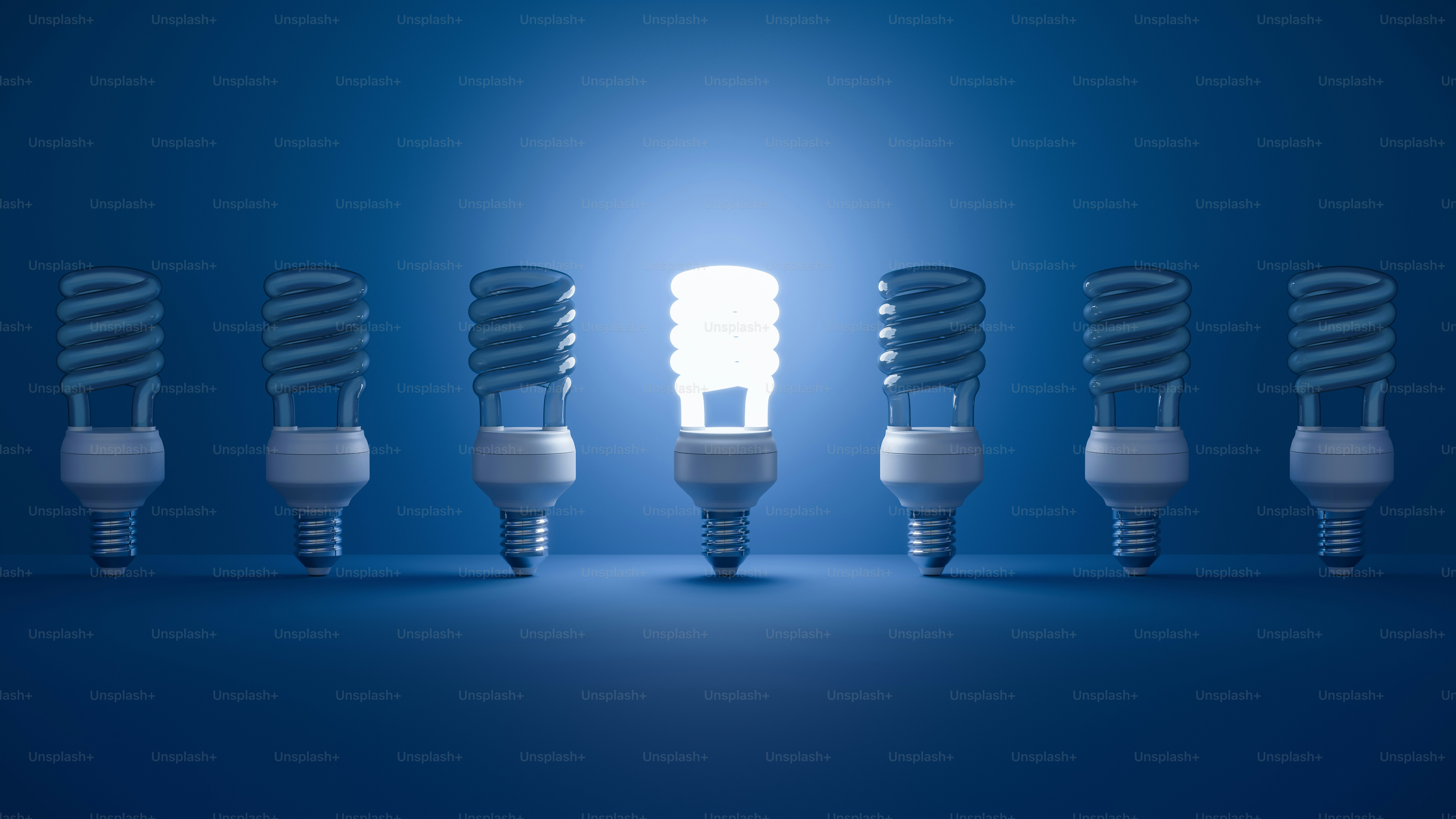 One lightbulb shines brightly among others.