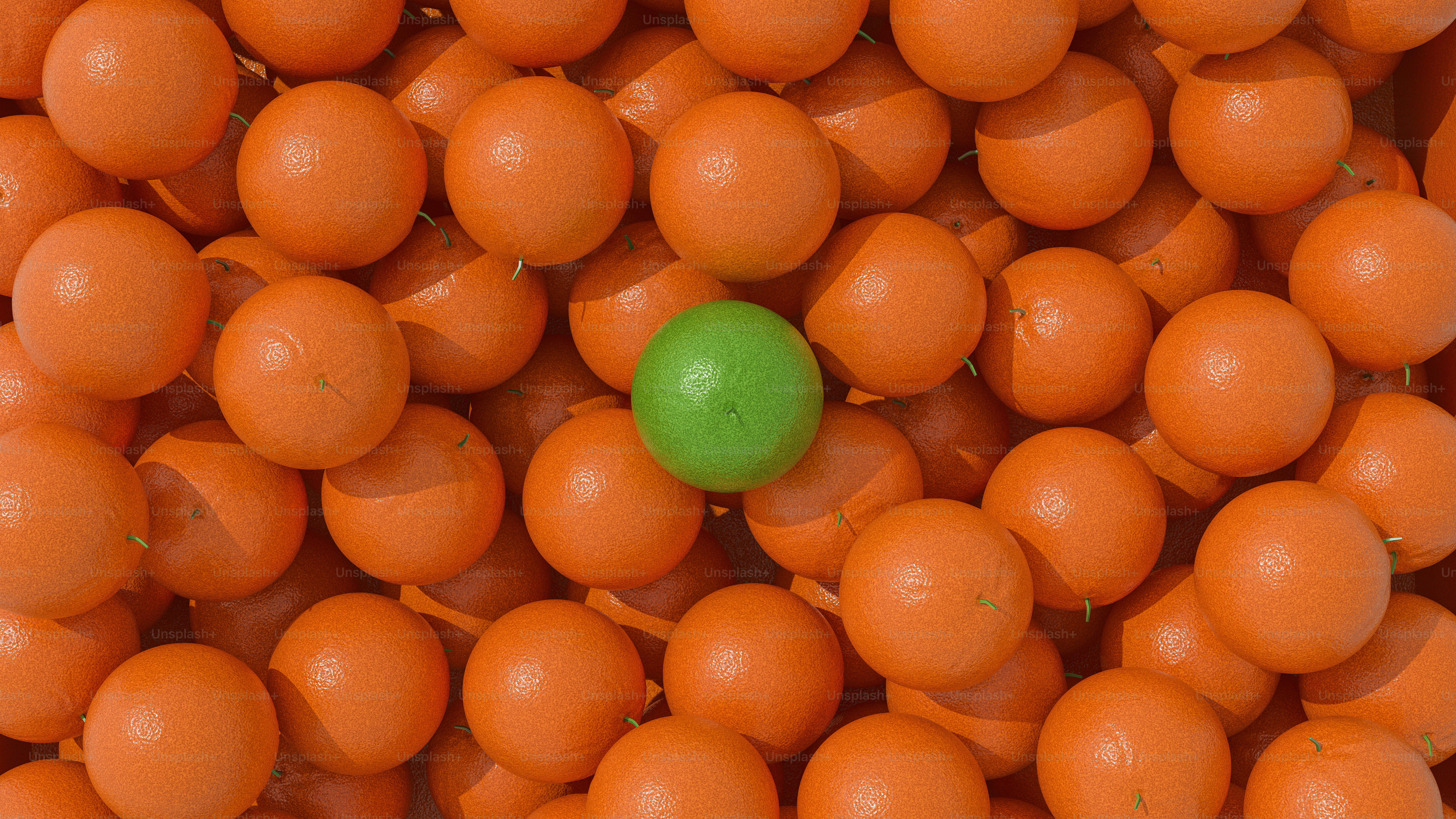 A green ball among many orange balls.