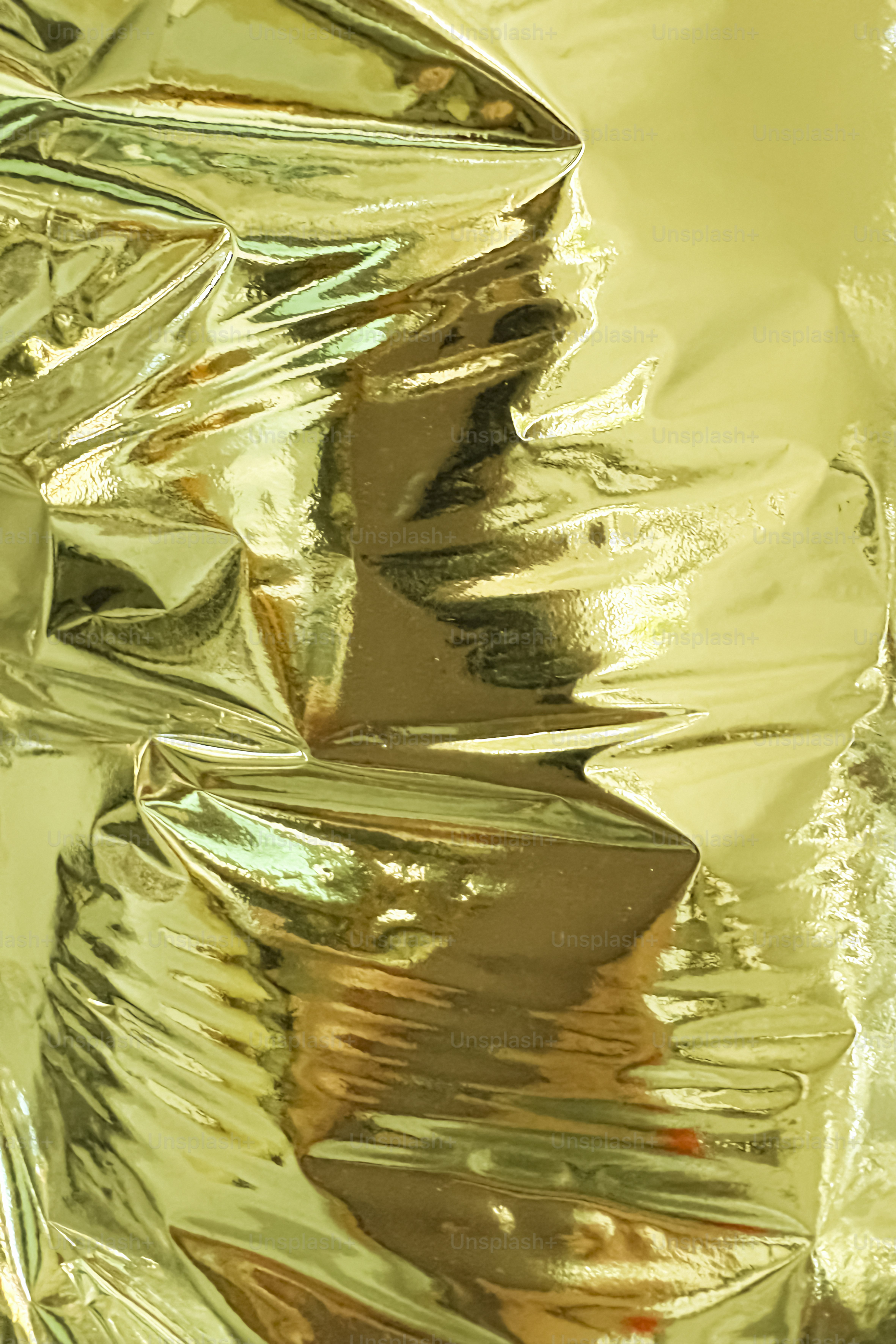 Wrinkled golden foil creates a shiny, textured background.