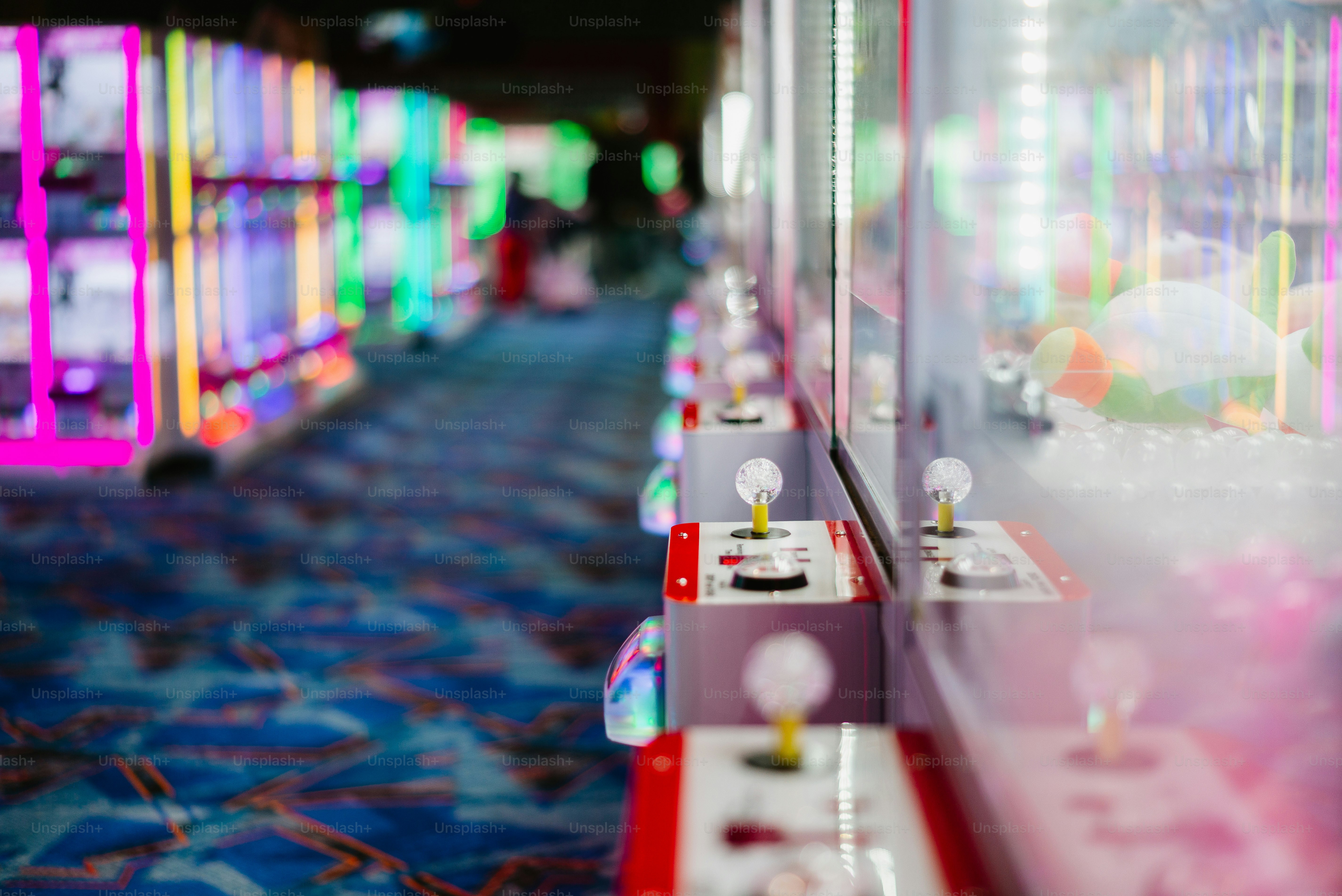 Arcade claw machines lined up in a row.