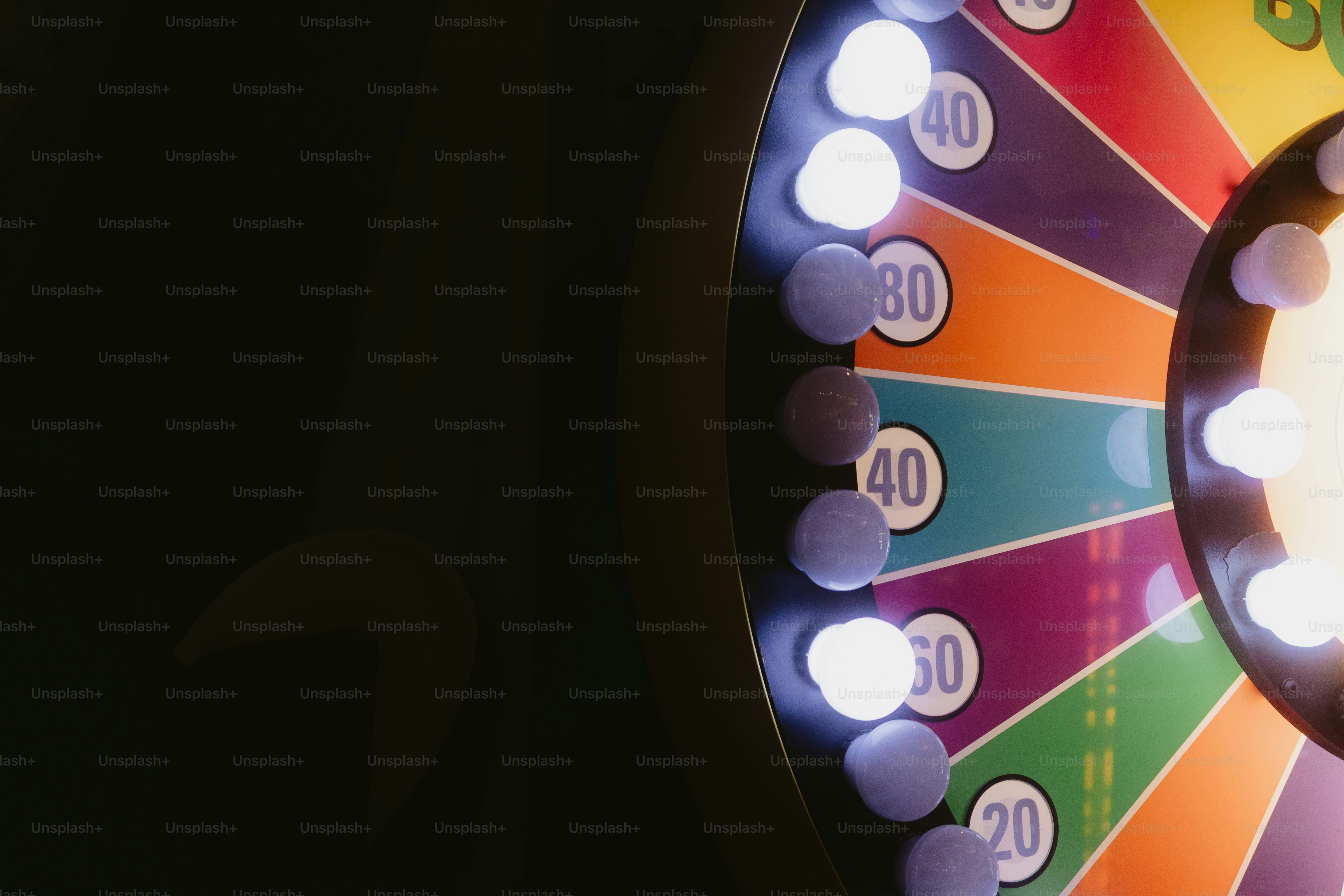 A colorful prize wheel is shown with lights.