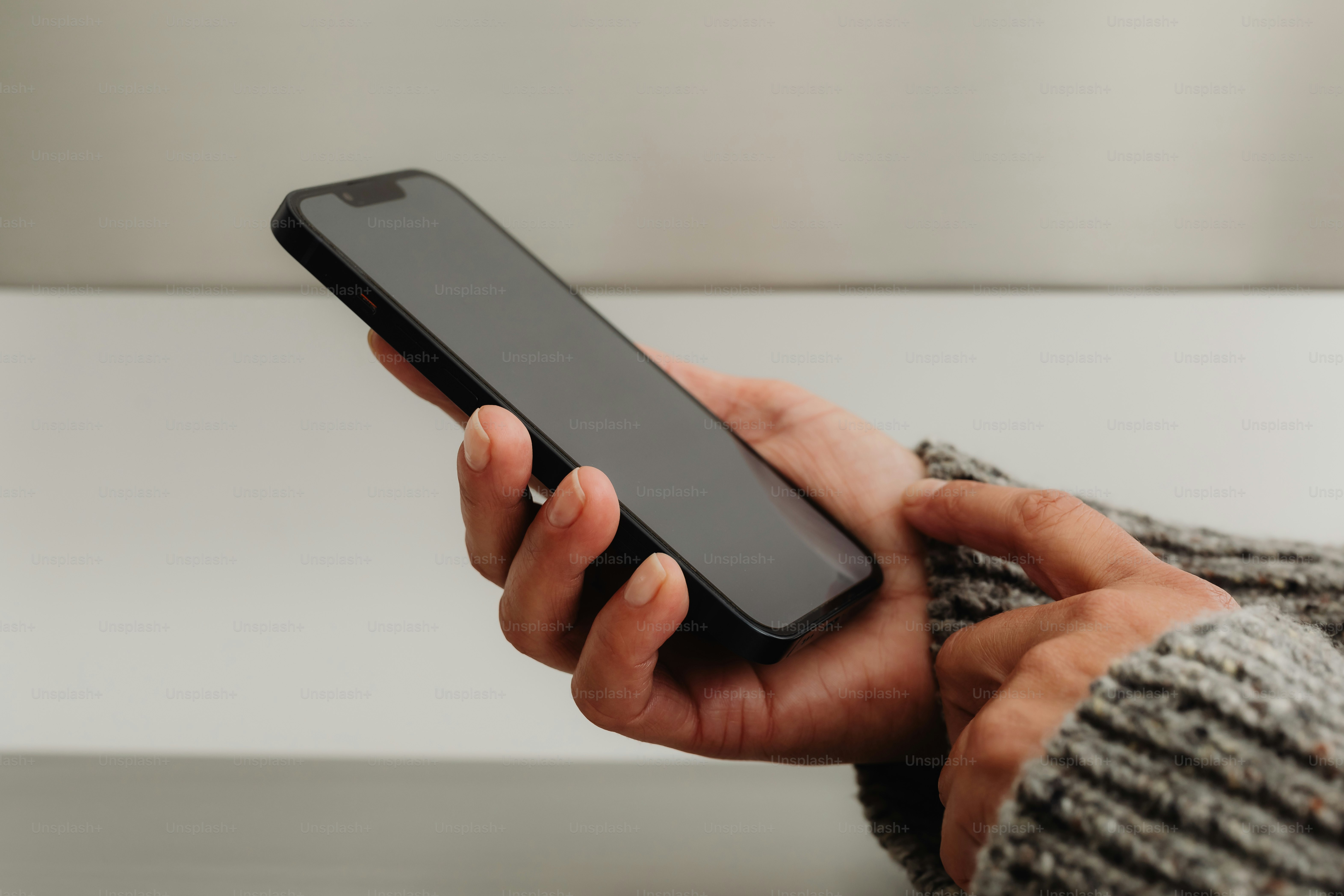 A person holds and uses a smartphone.