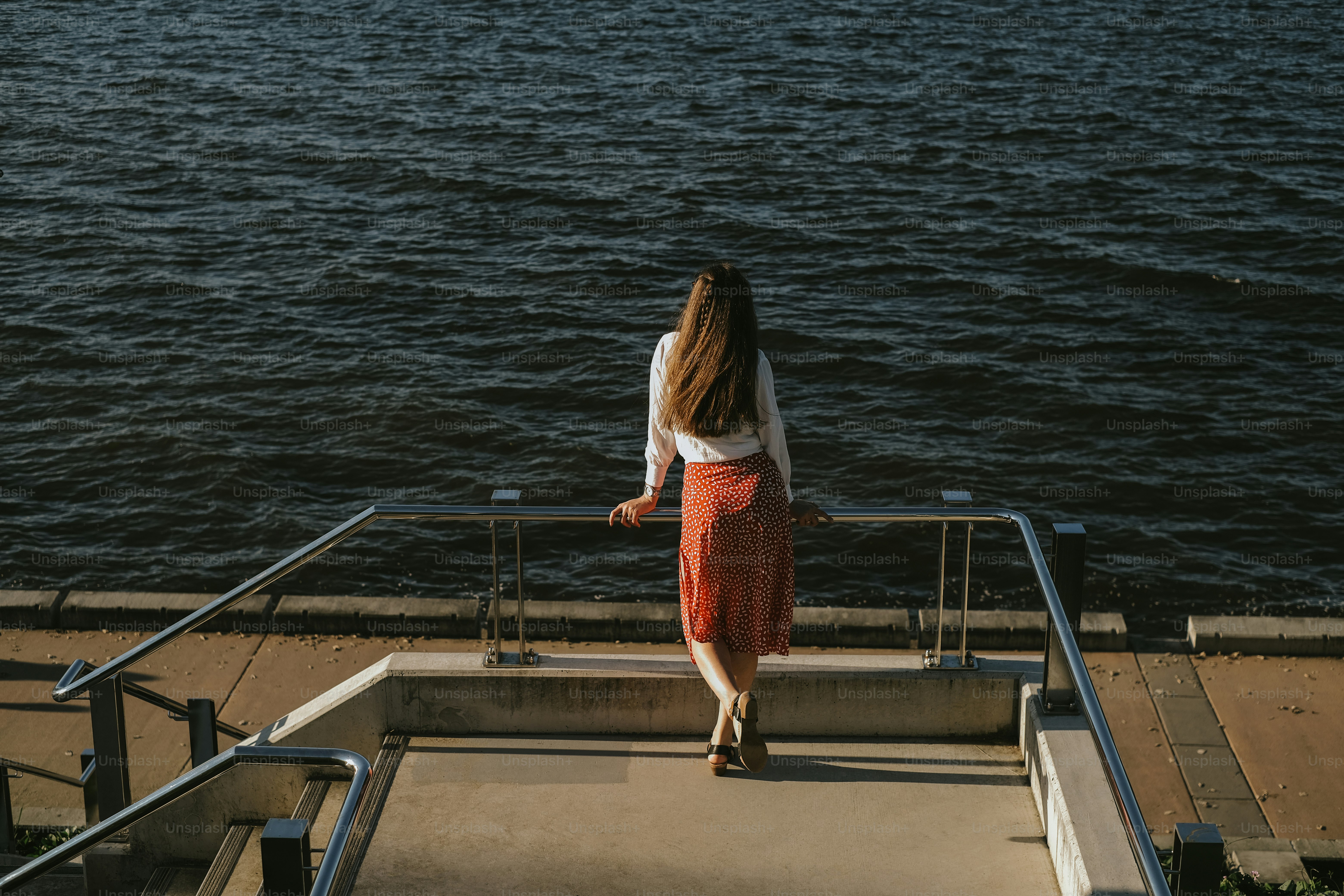 A woman gazes out at the water.