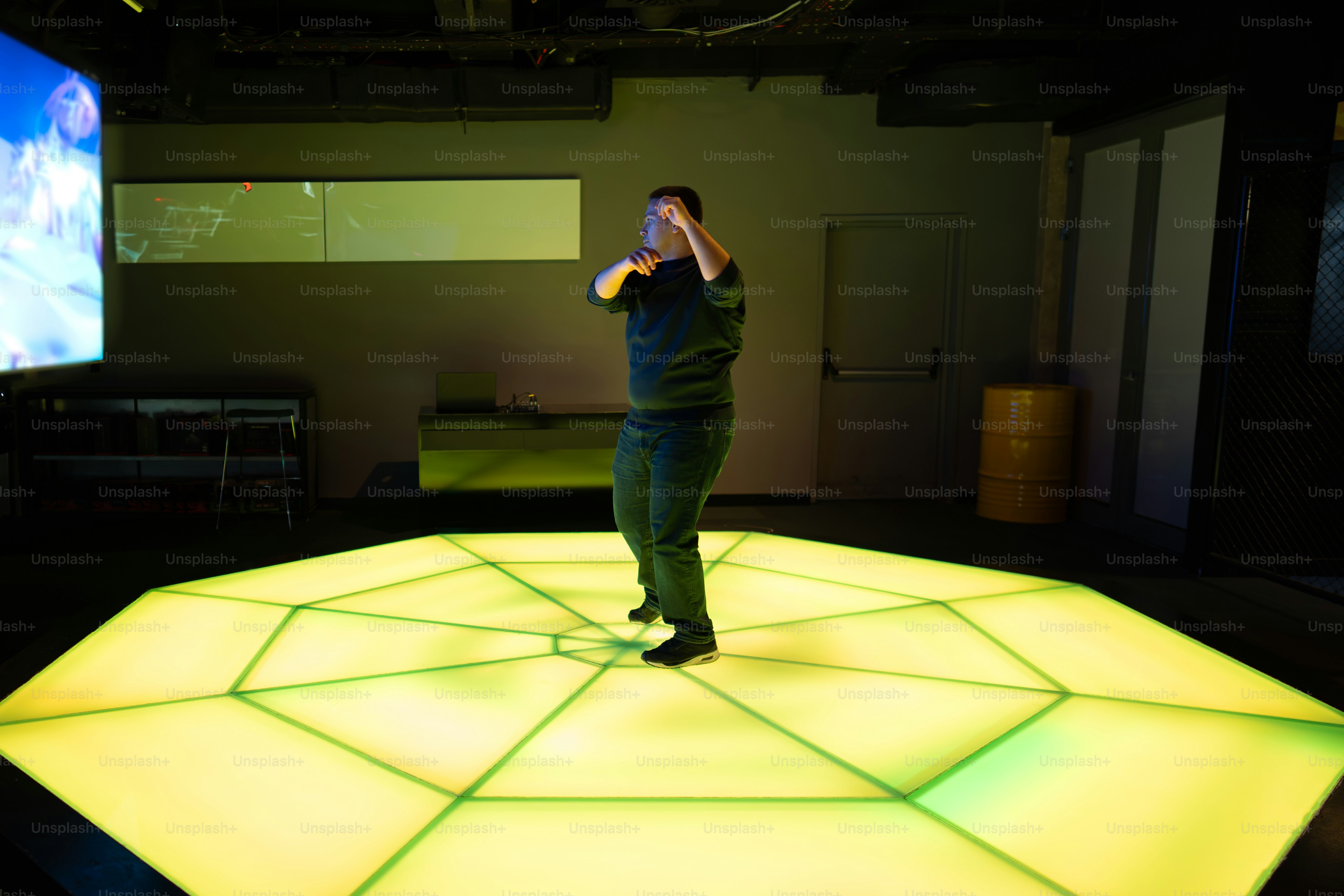 A person is dancing on a glowing stage.