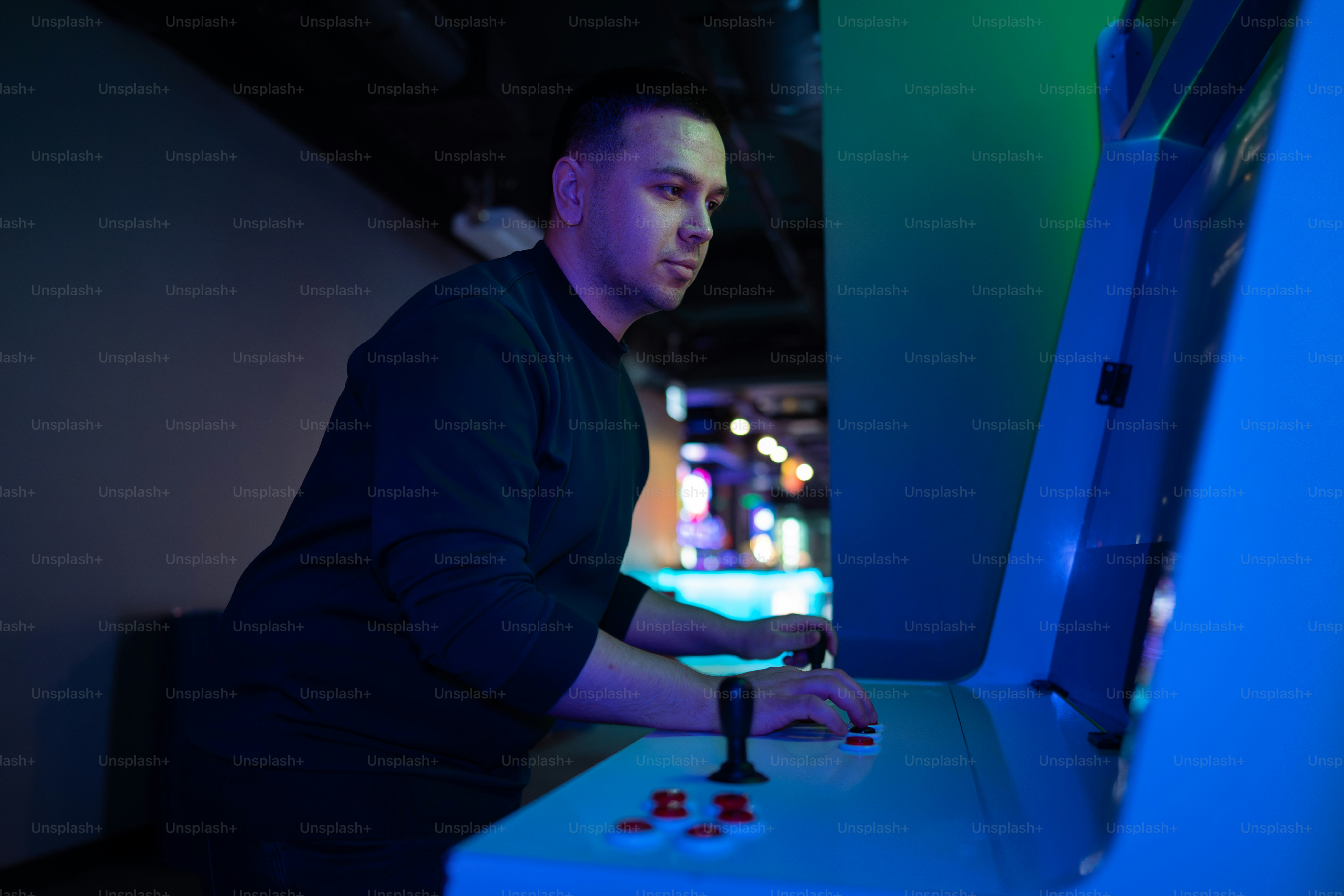 A man plays an arcade game.