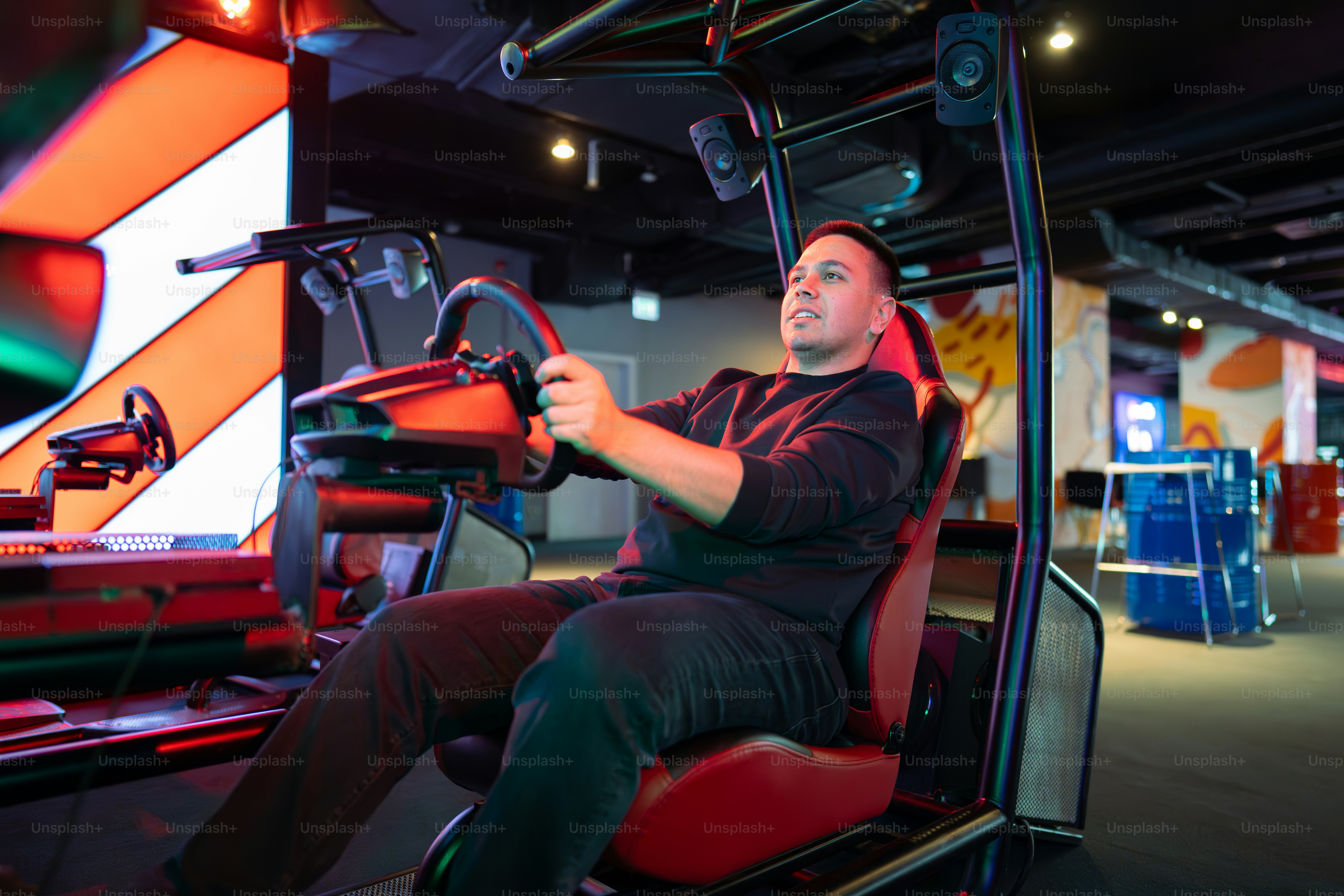 Man playing a racing game in a simulator. photo – Gaming Image on Unsplash