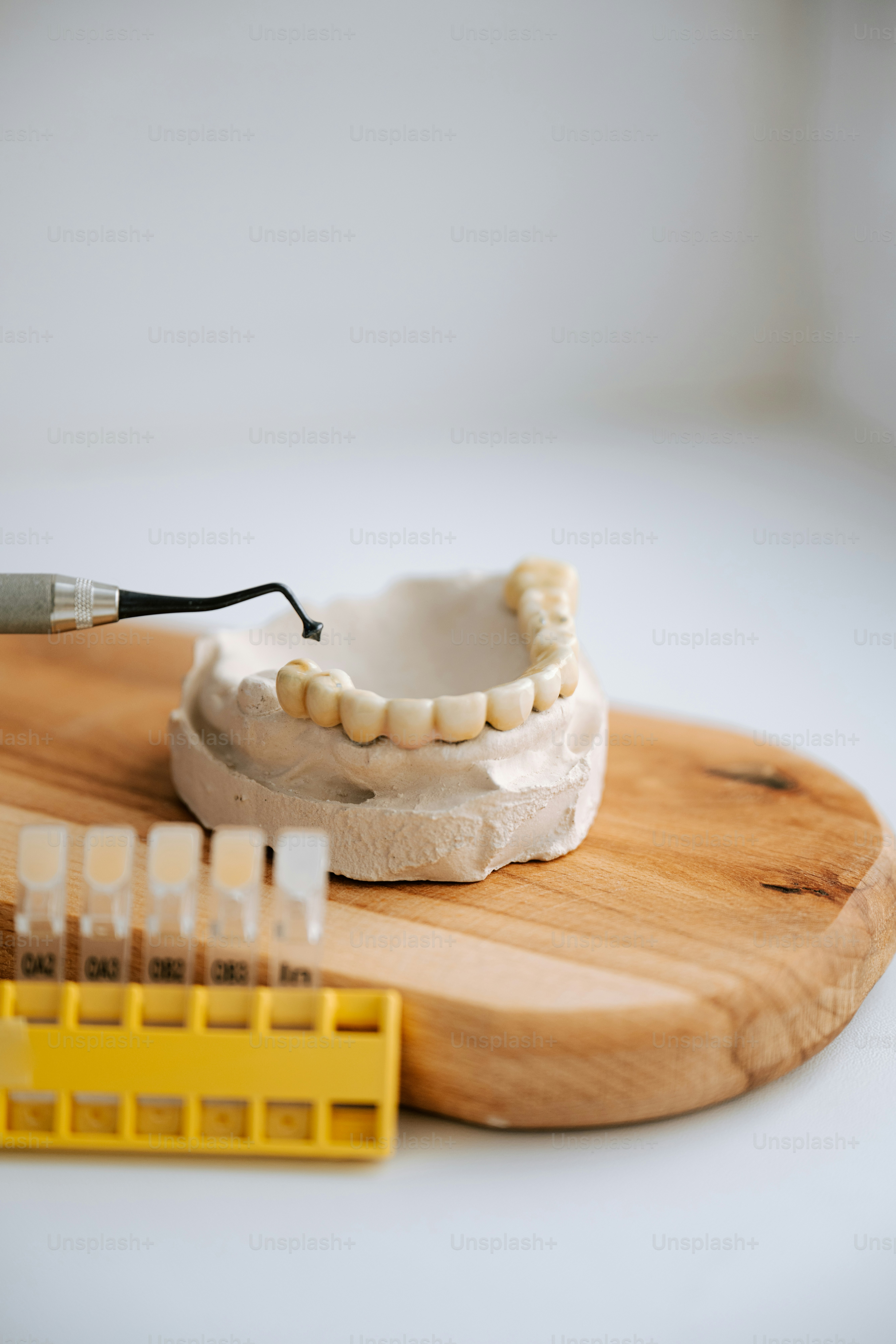 Dental prosthetics being adjusted for perfect match.