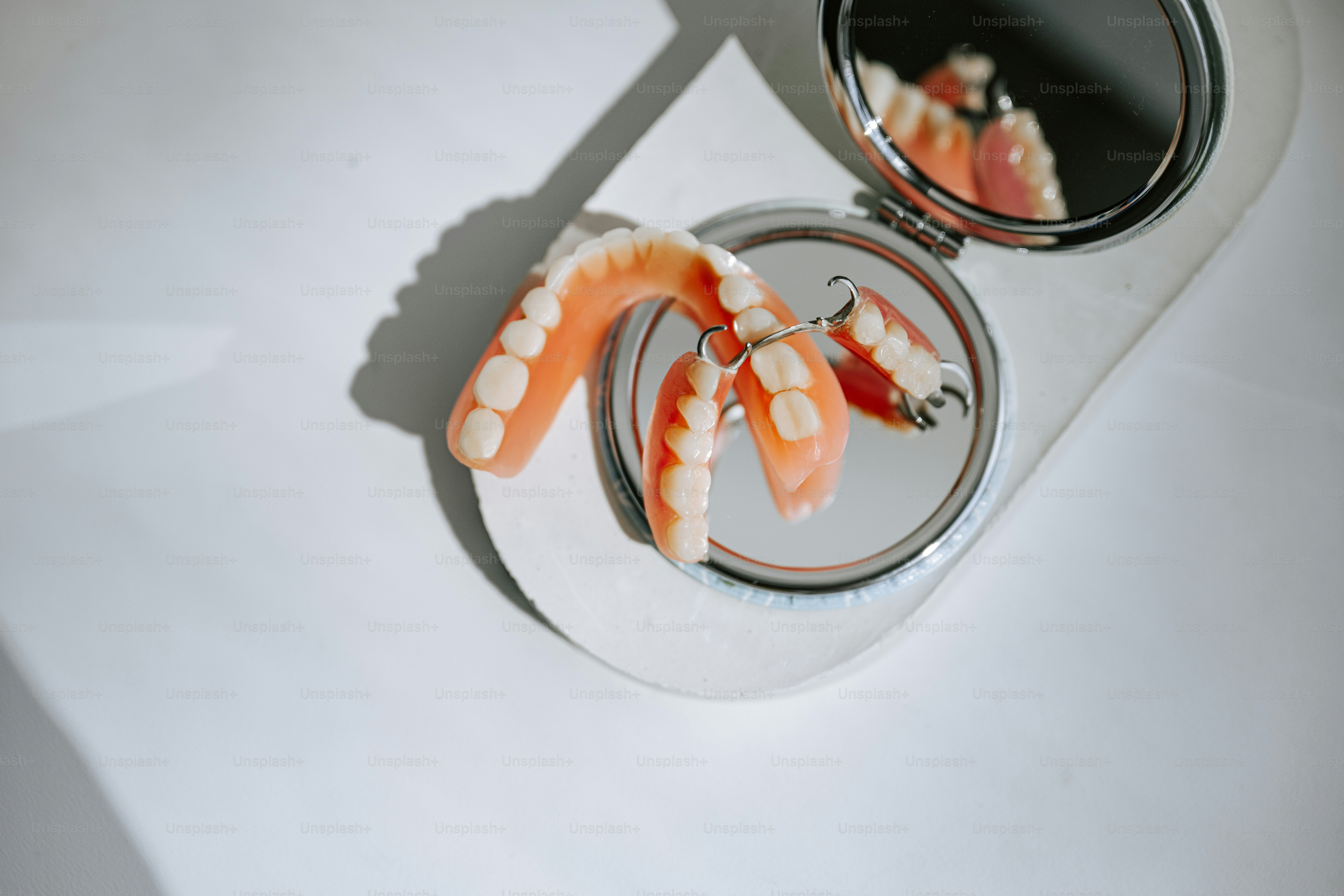 Dentures and a small mirror are shown.