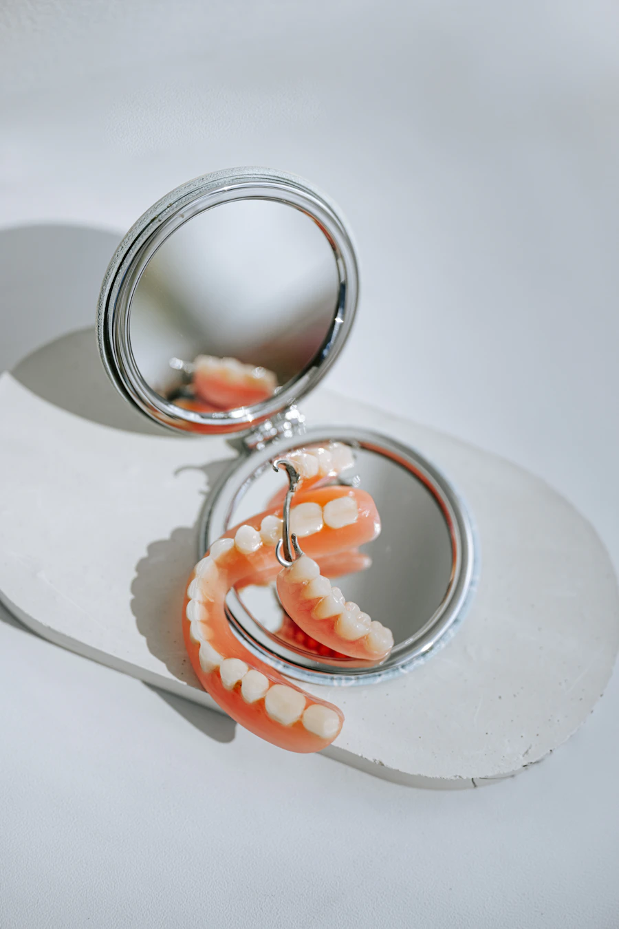 close up of dental plate denture on white surface clean clinical detail product photograph studio lighting simple background