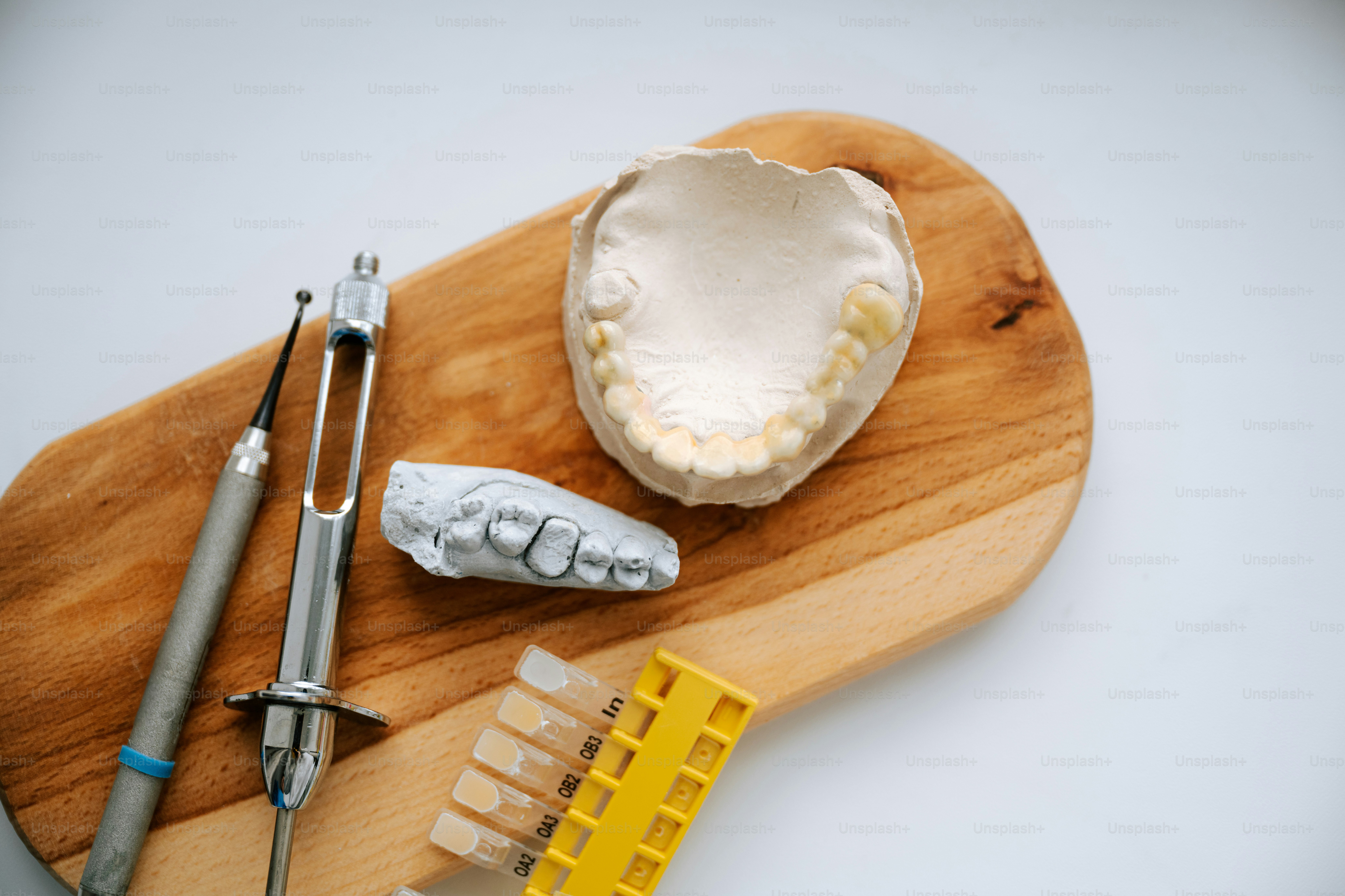 Dental tools and a mold of teeth.