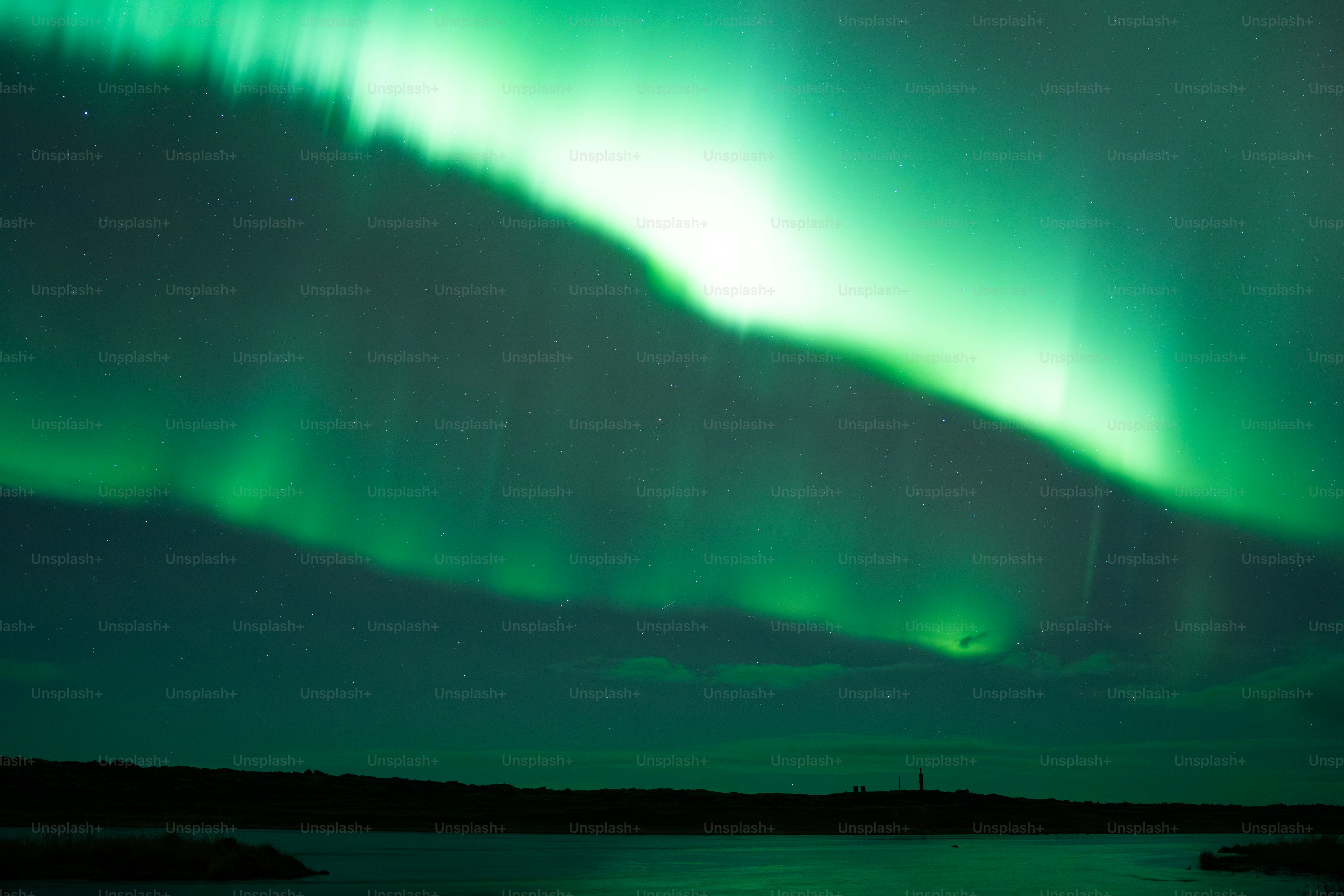 The northern lights illuminate the dark sky.