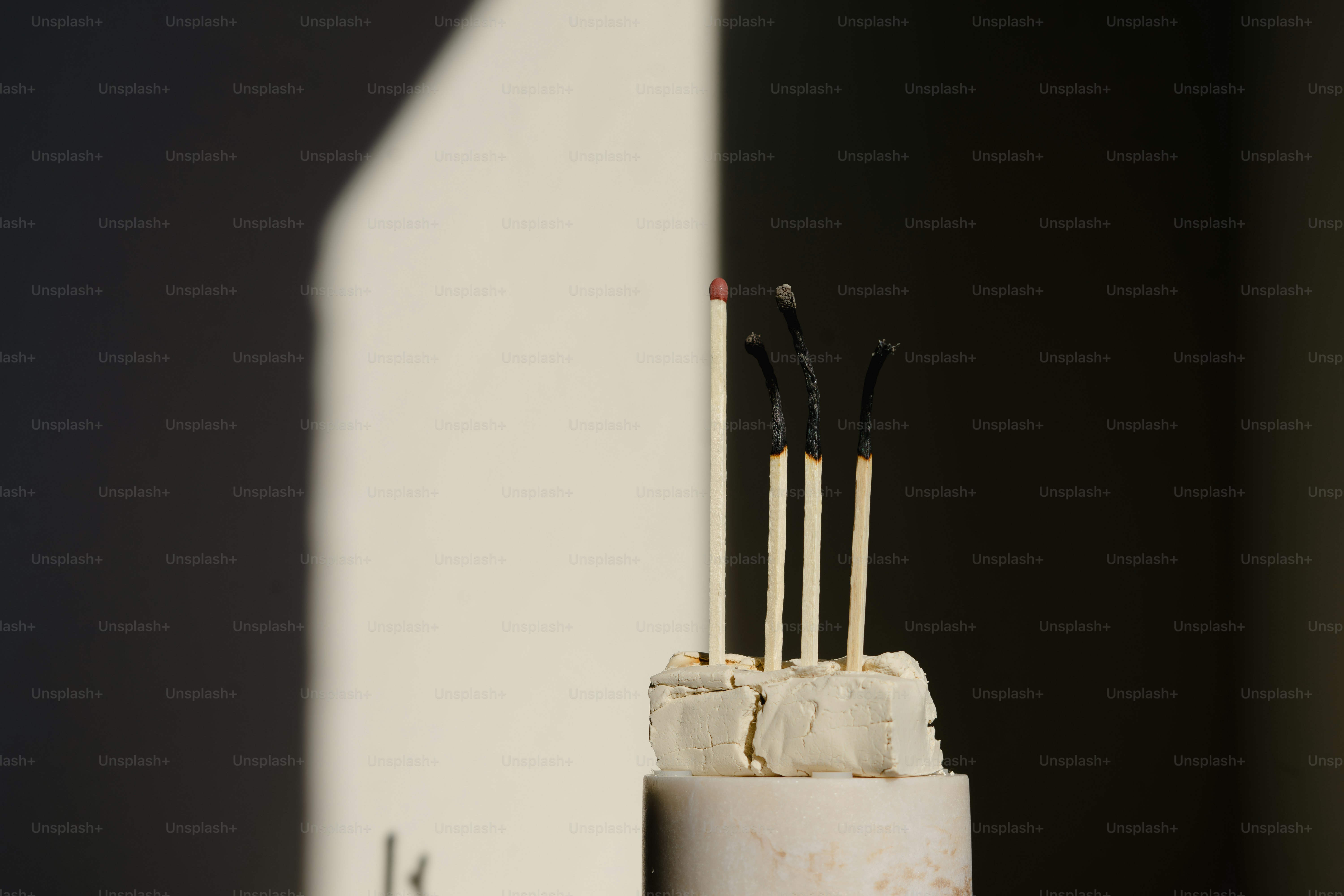 Burnt matches stand in a white substance.