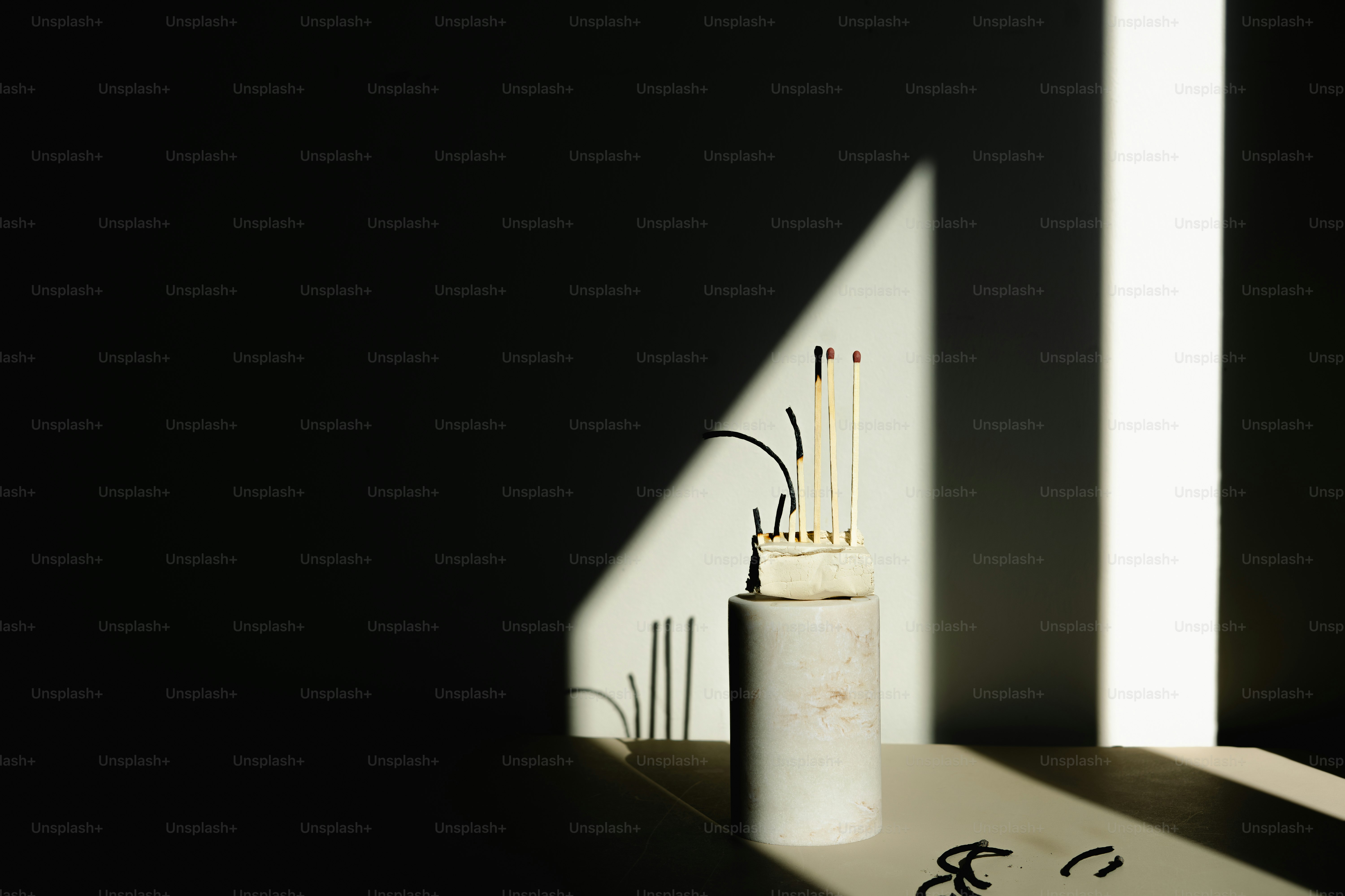 A sculpture casts striking shadows on a wall.