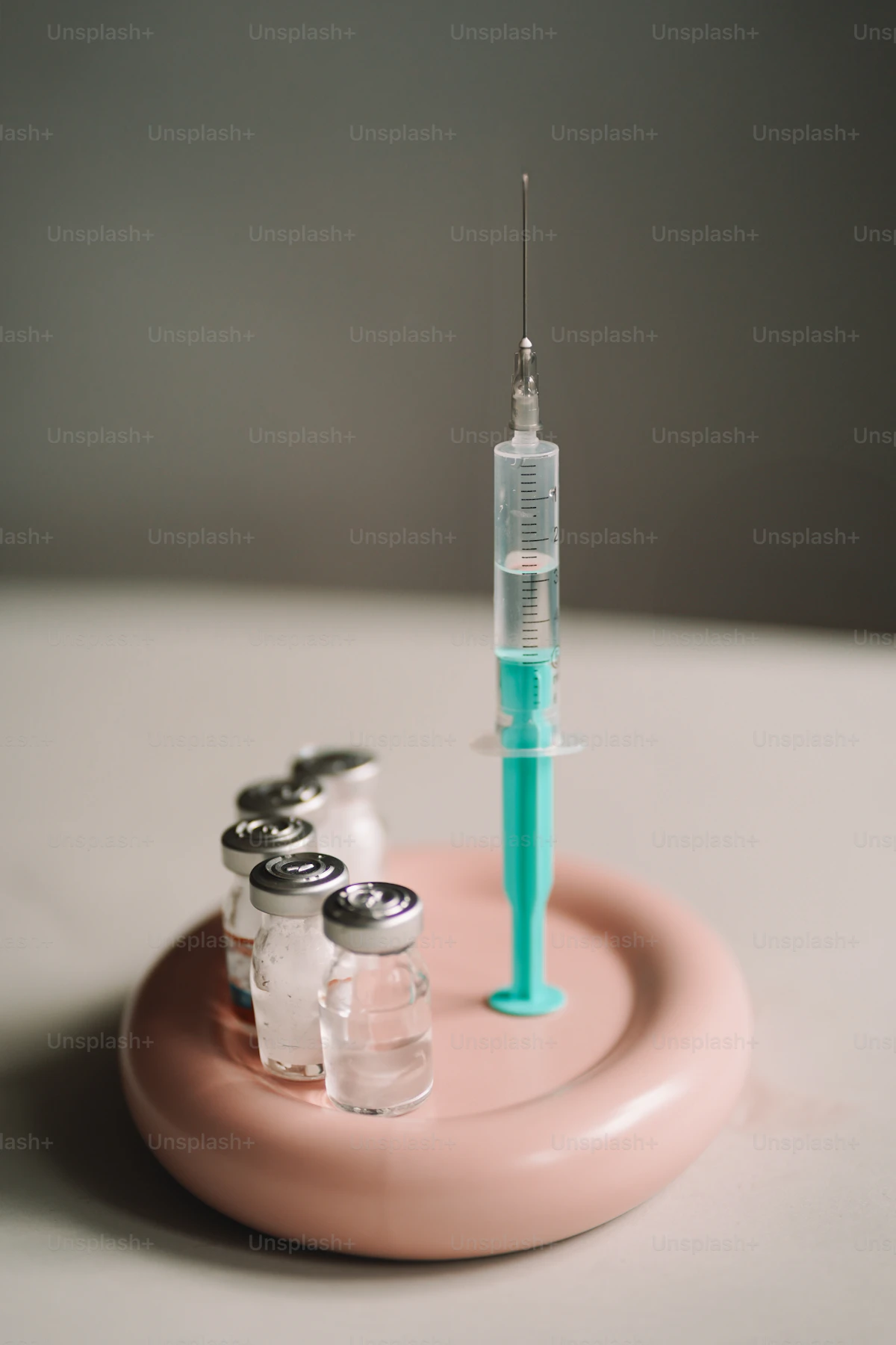 A vaccine vial and syringe prepared on a sterile tray