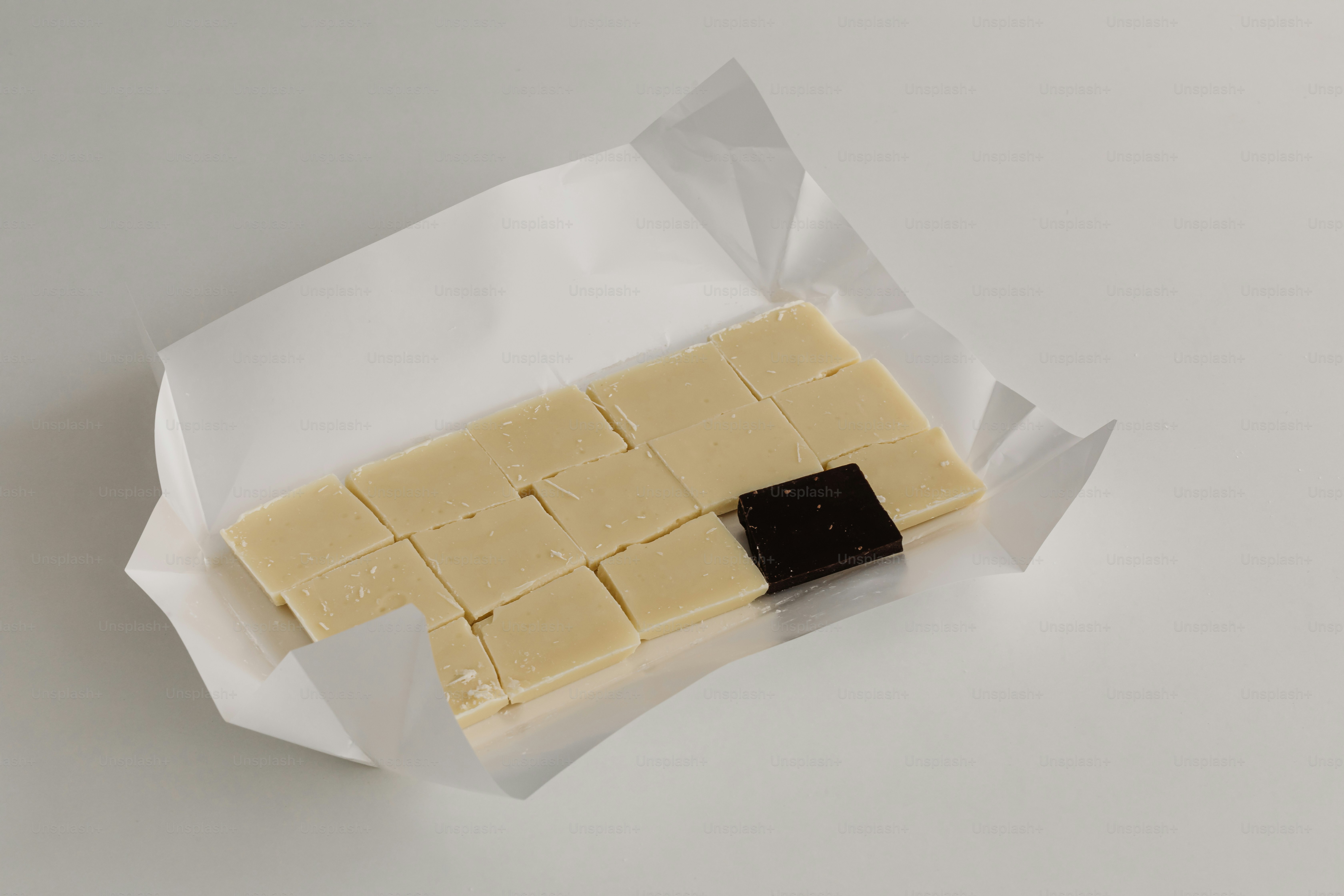 White chocolate bar, partially wrapped and cut.