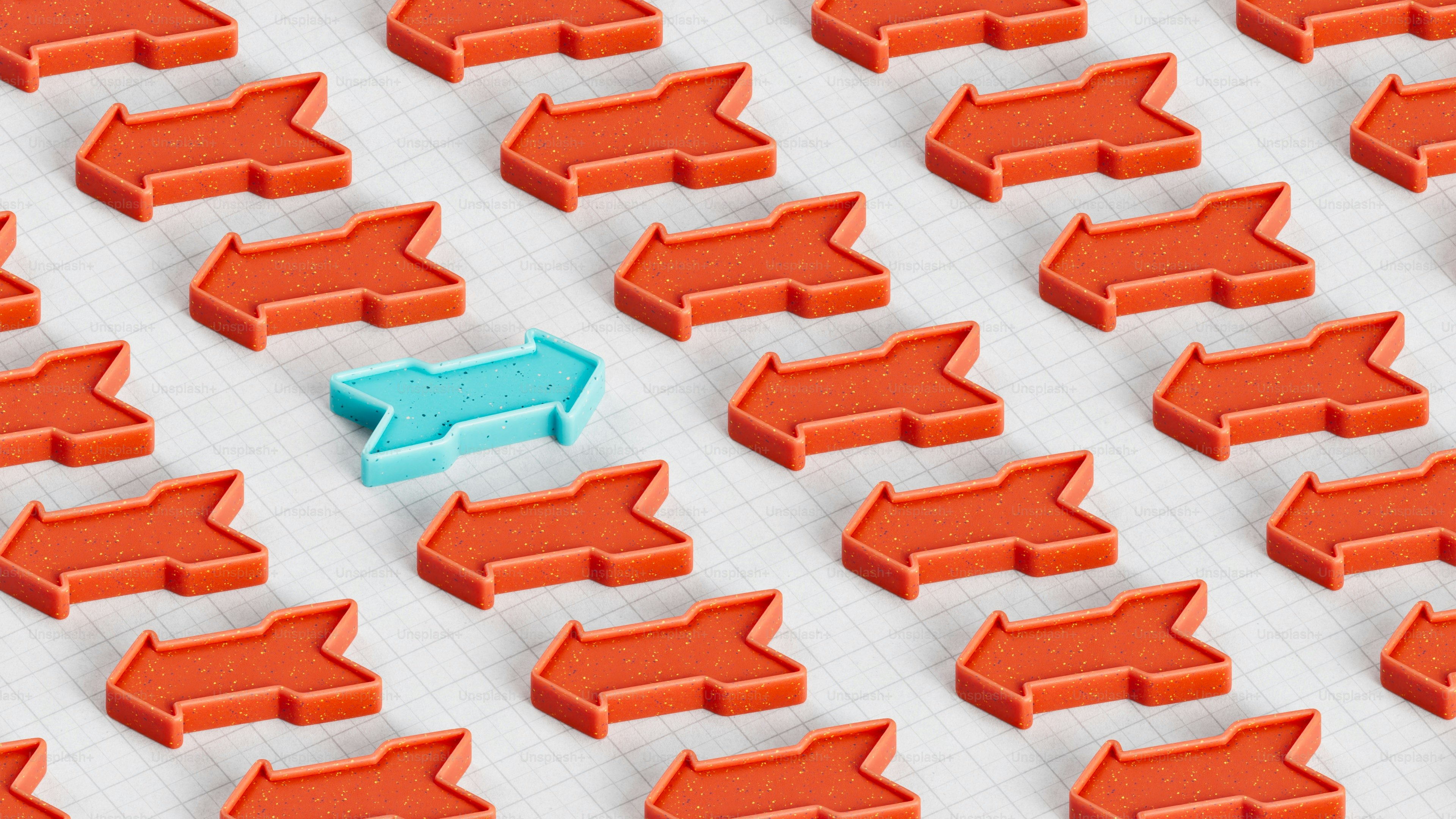One blue arrow stands out from many red ones.