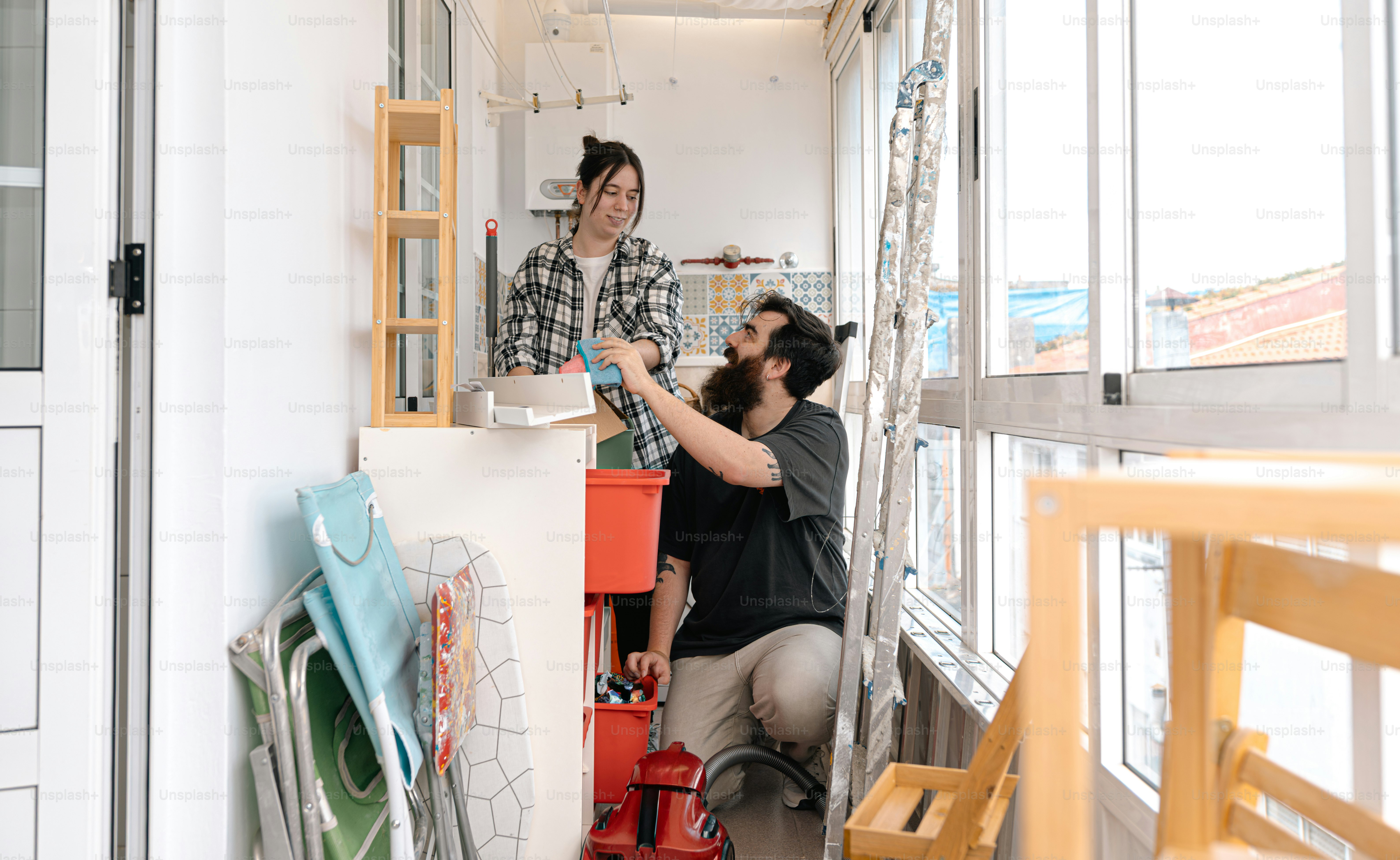 People are working together to organize a small space.