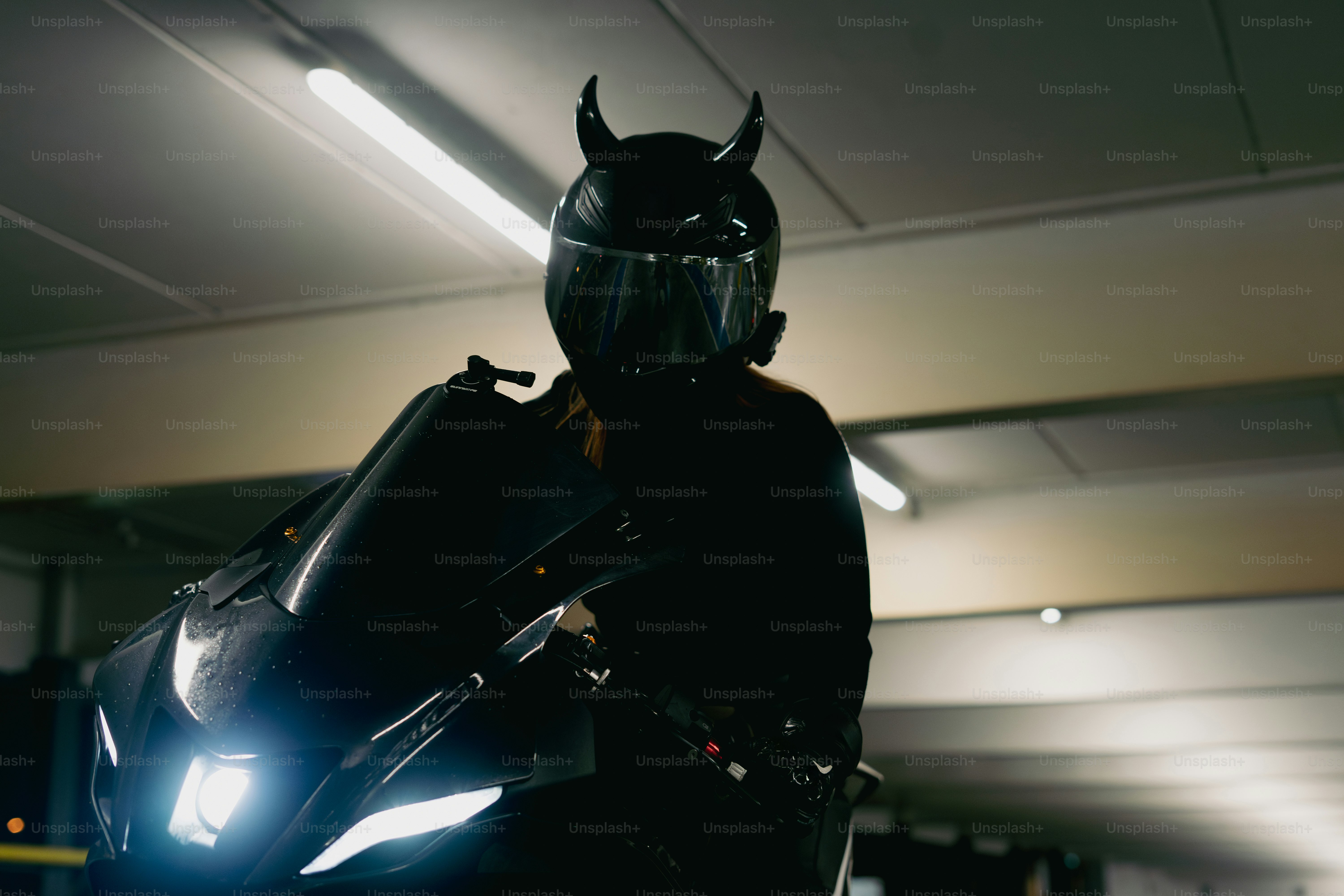 A devil-horned biker prepares for a ride.