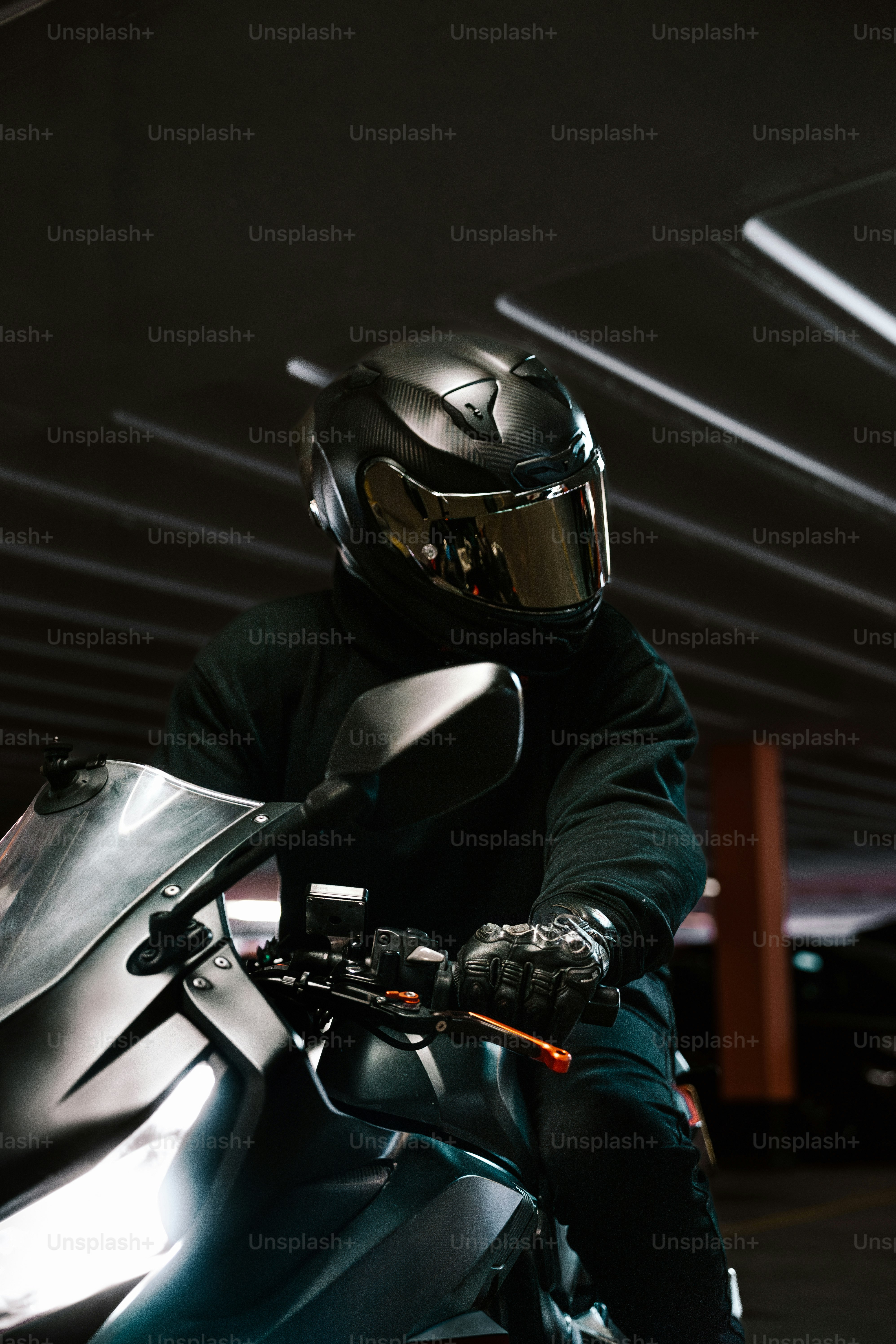 A person on a motorcycle is ready to ride.