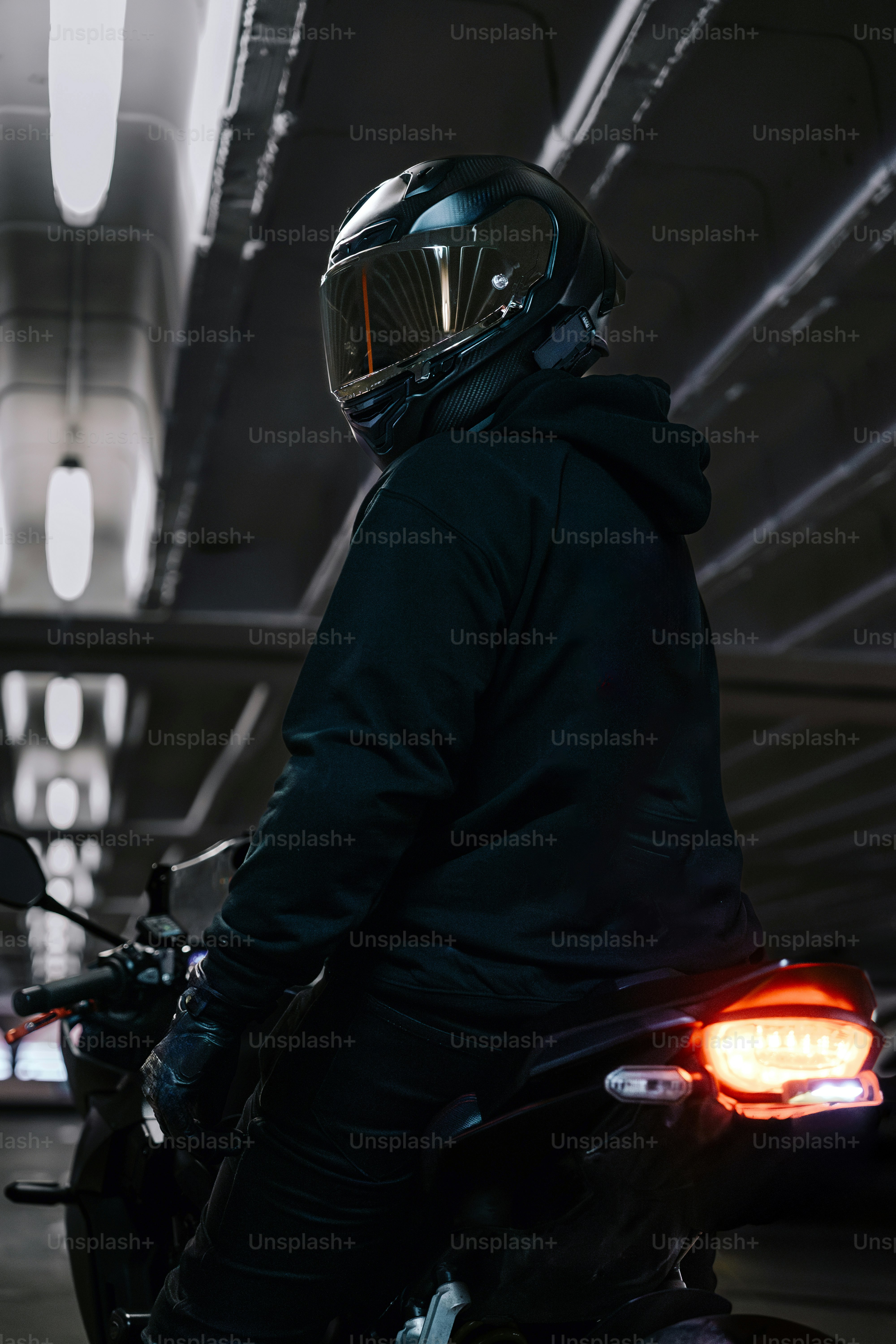 A motorcyclist wears a helmet and is ready to ride.