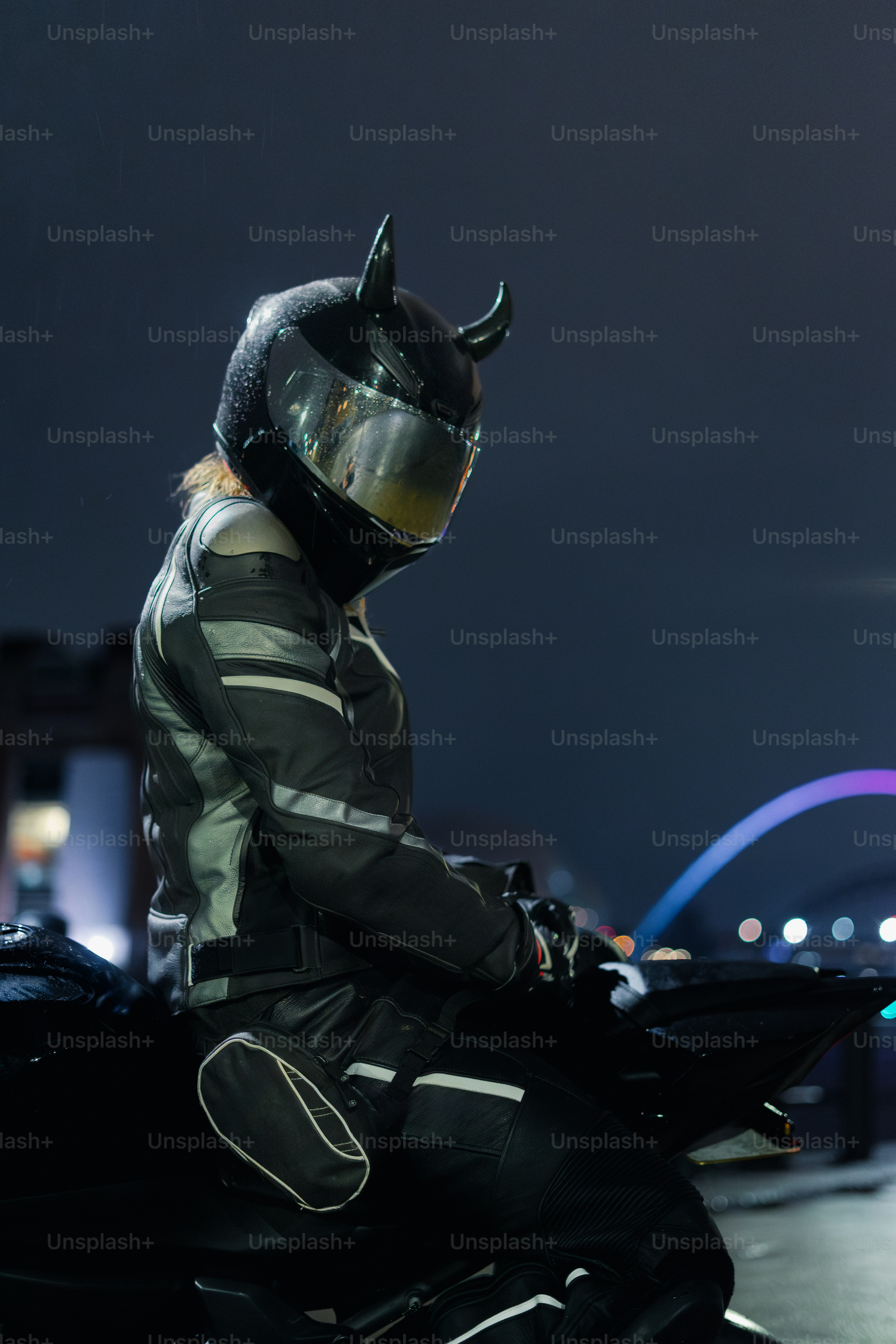 A person with devil horns is riding a motorcycle. photo  Travel Image on  Unsplash
