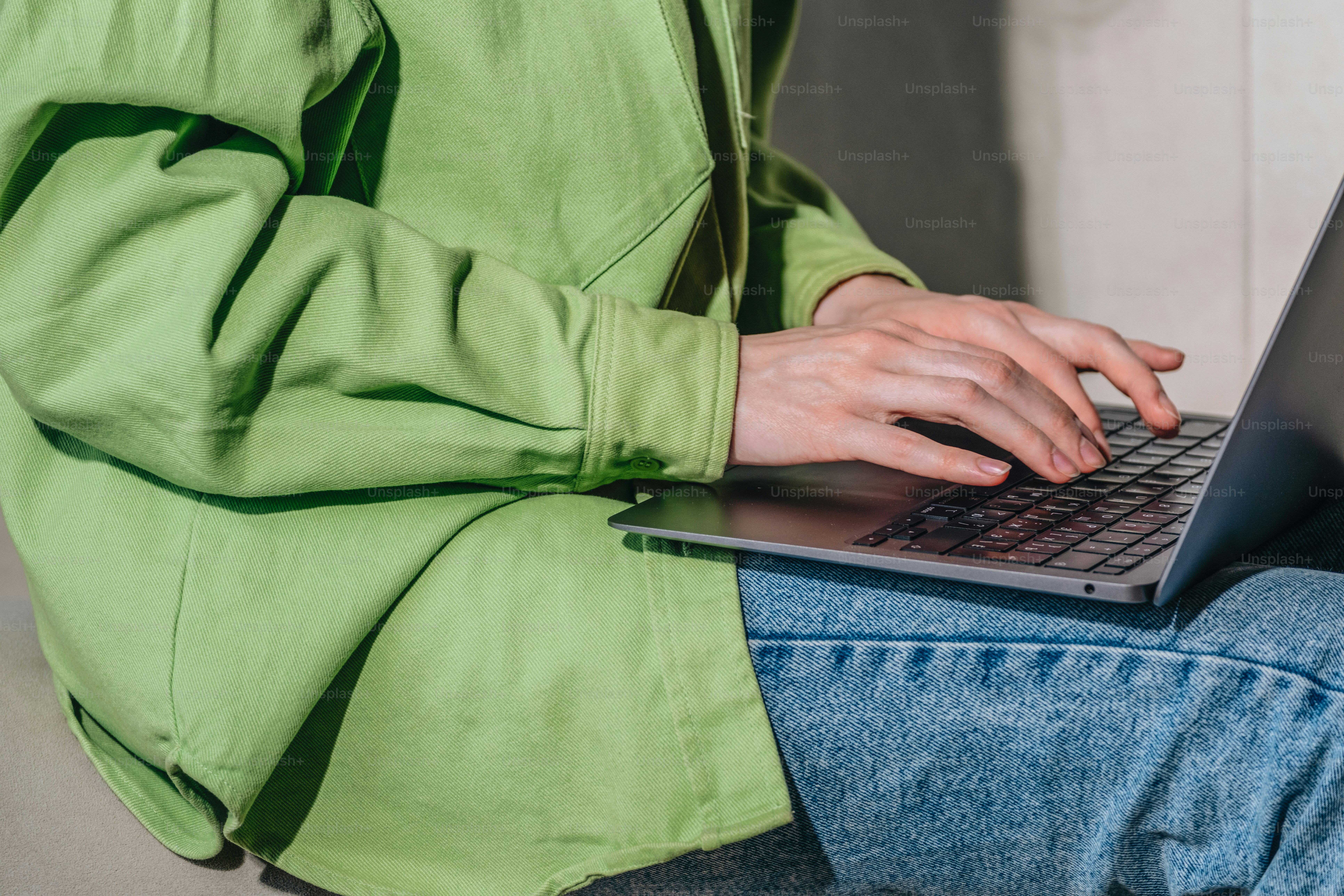 Someone is working on a laptop, typing.