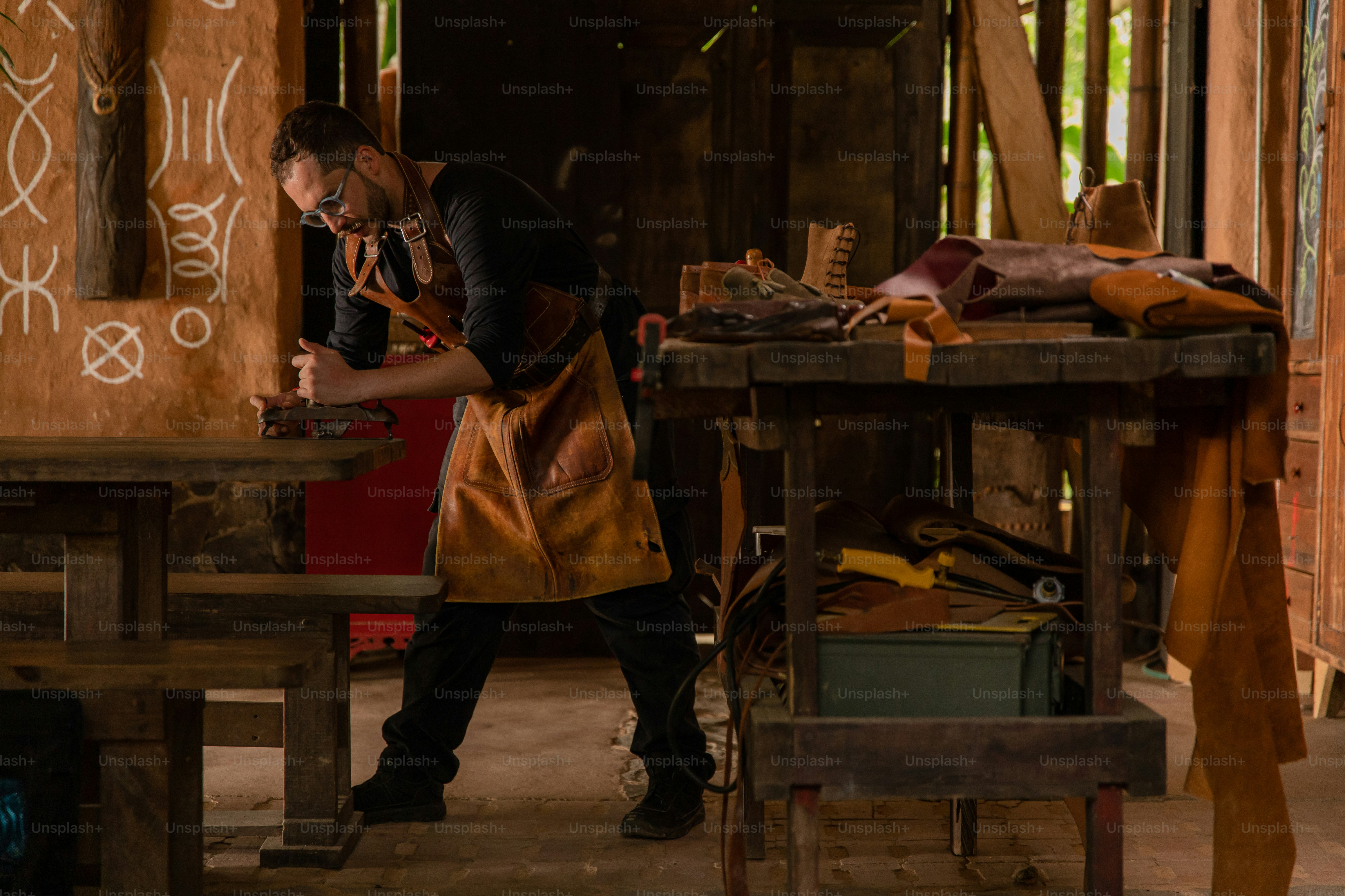 A craftsman works at his workbench.
