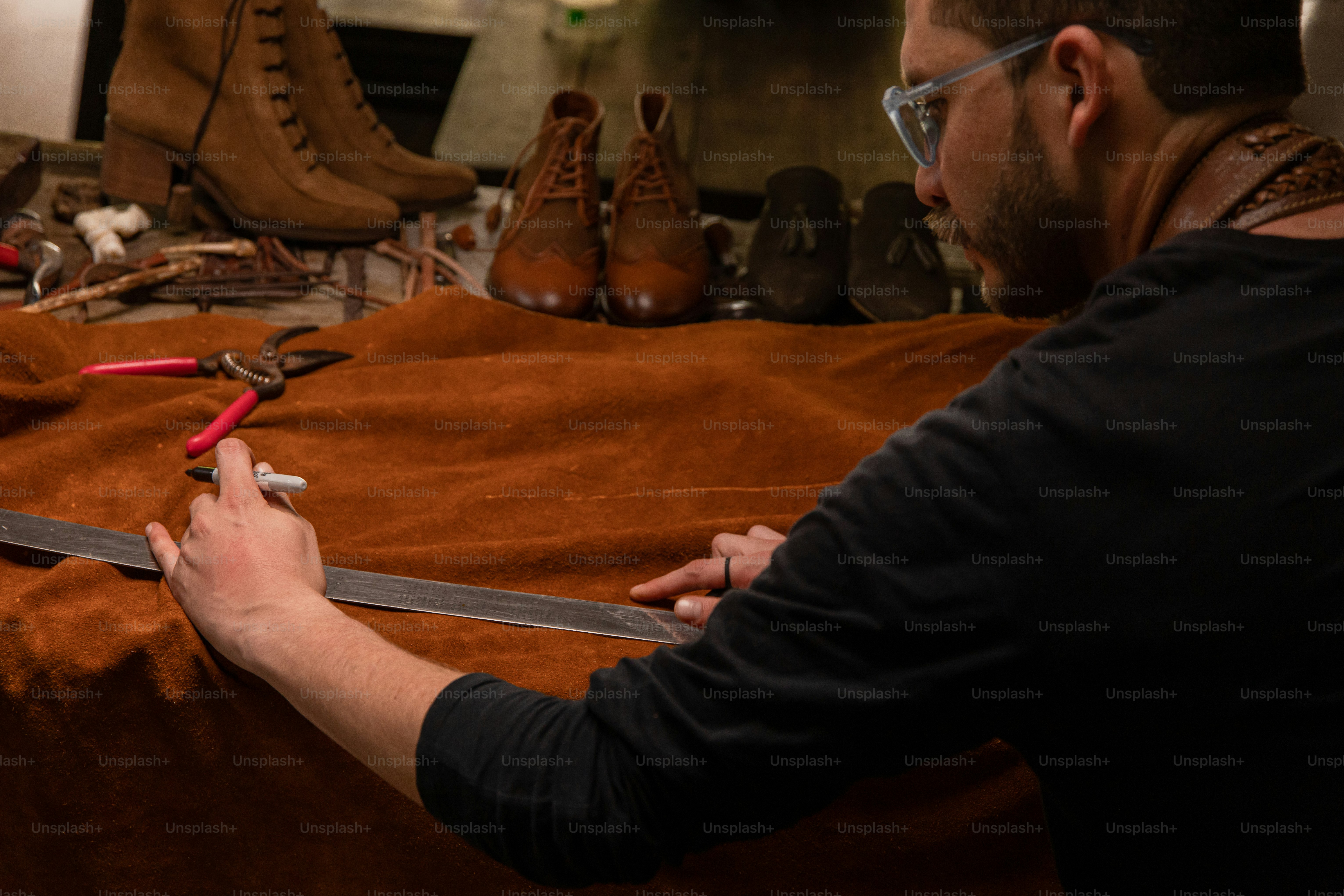 Shoemaker measuring leather to craft a new shoe.