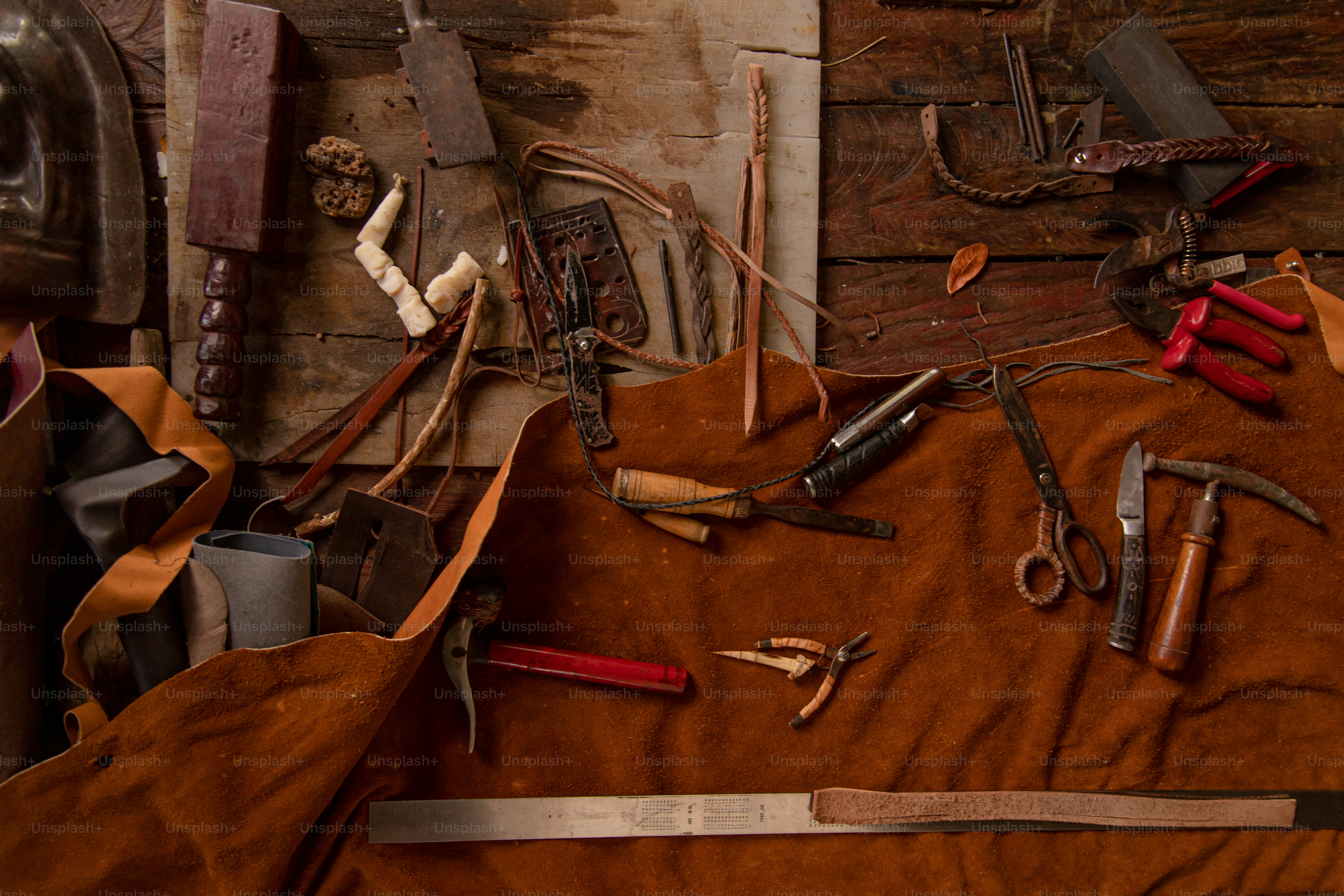 Leatherworking tools scattered on a work surface.