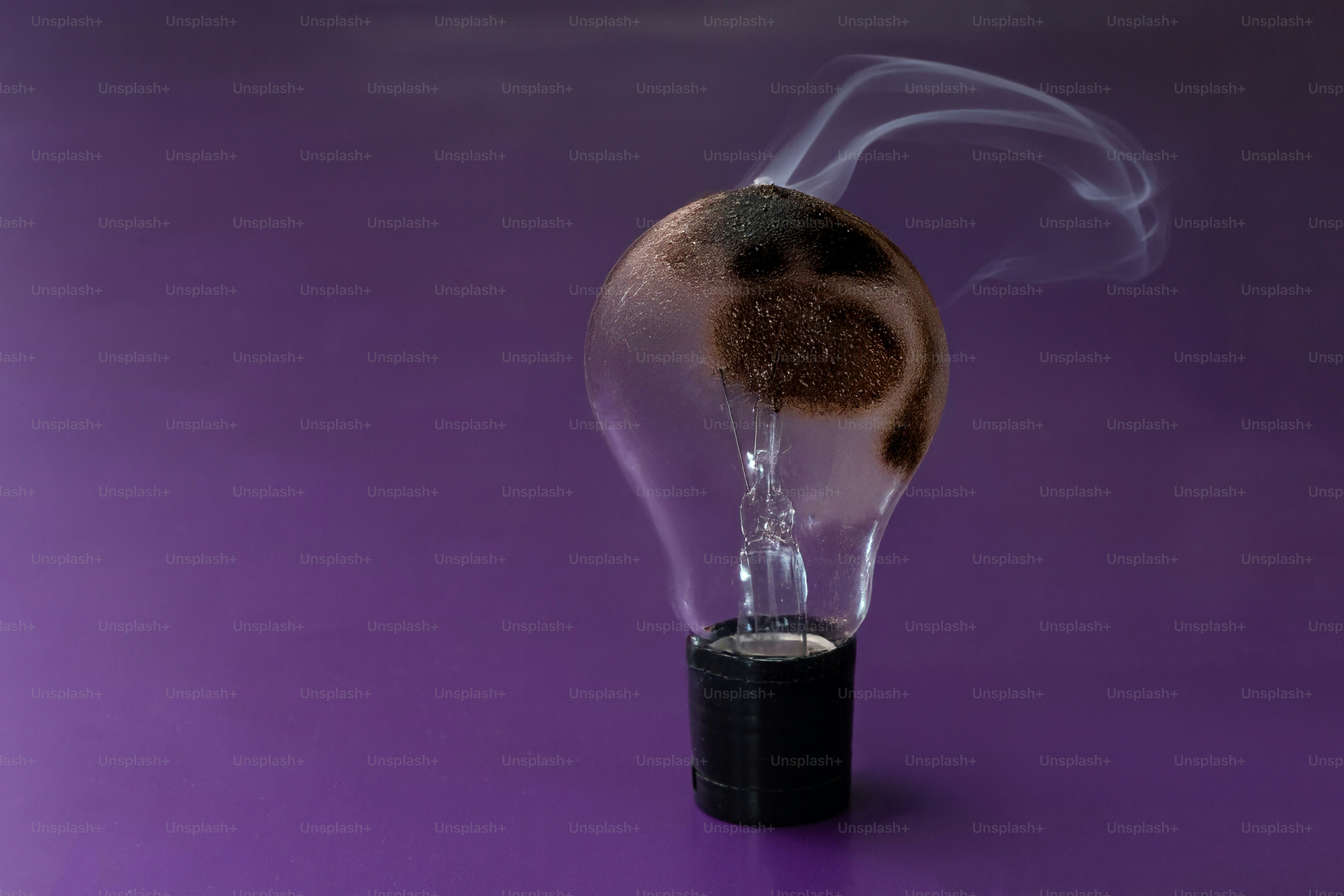 A burnt-out lightbulb emits smoke.
