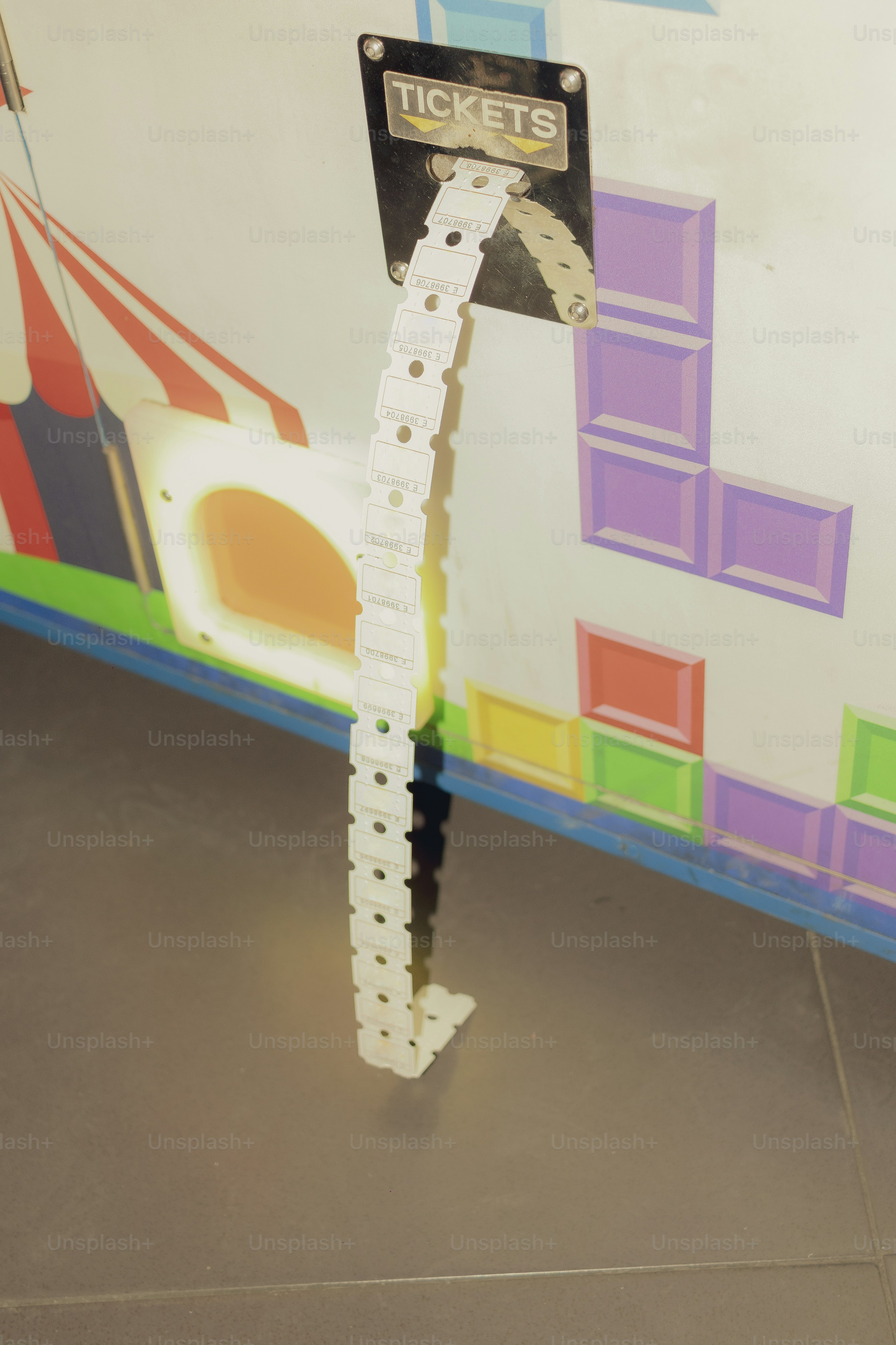 Tickets are dispensing from a machine. photo – Gaming Image on Unsplash