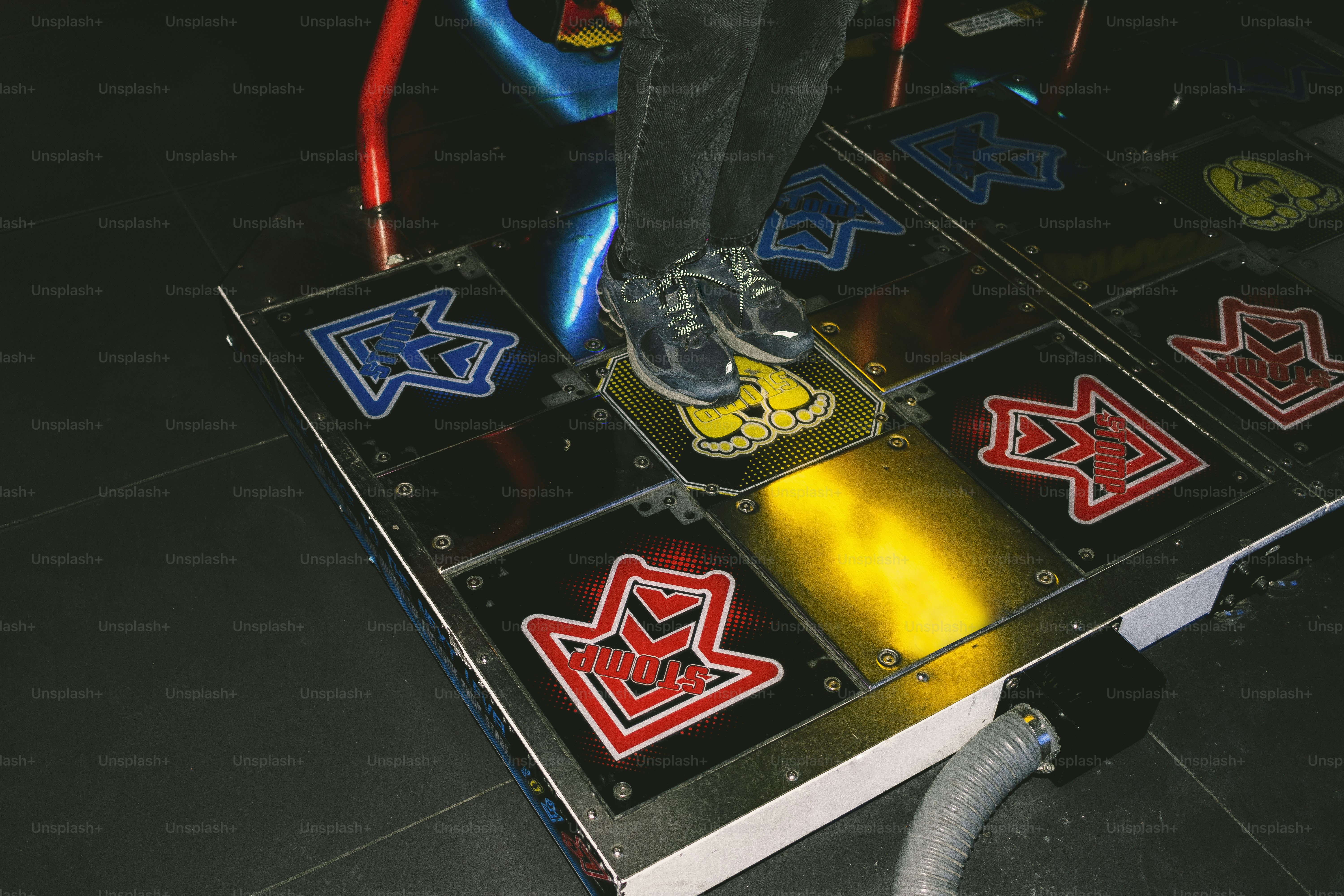 Person plays dance game on a dance pad.