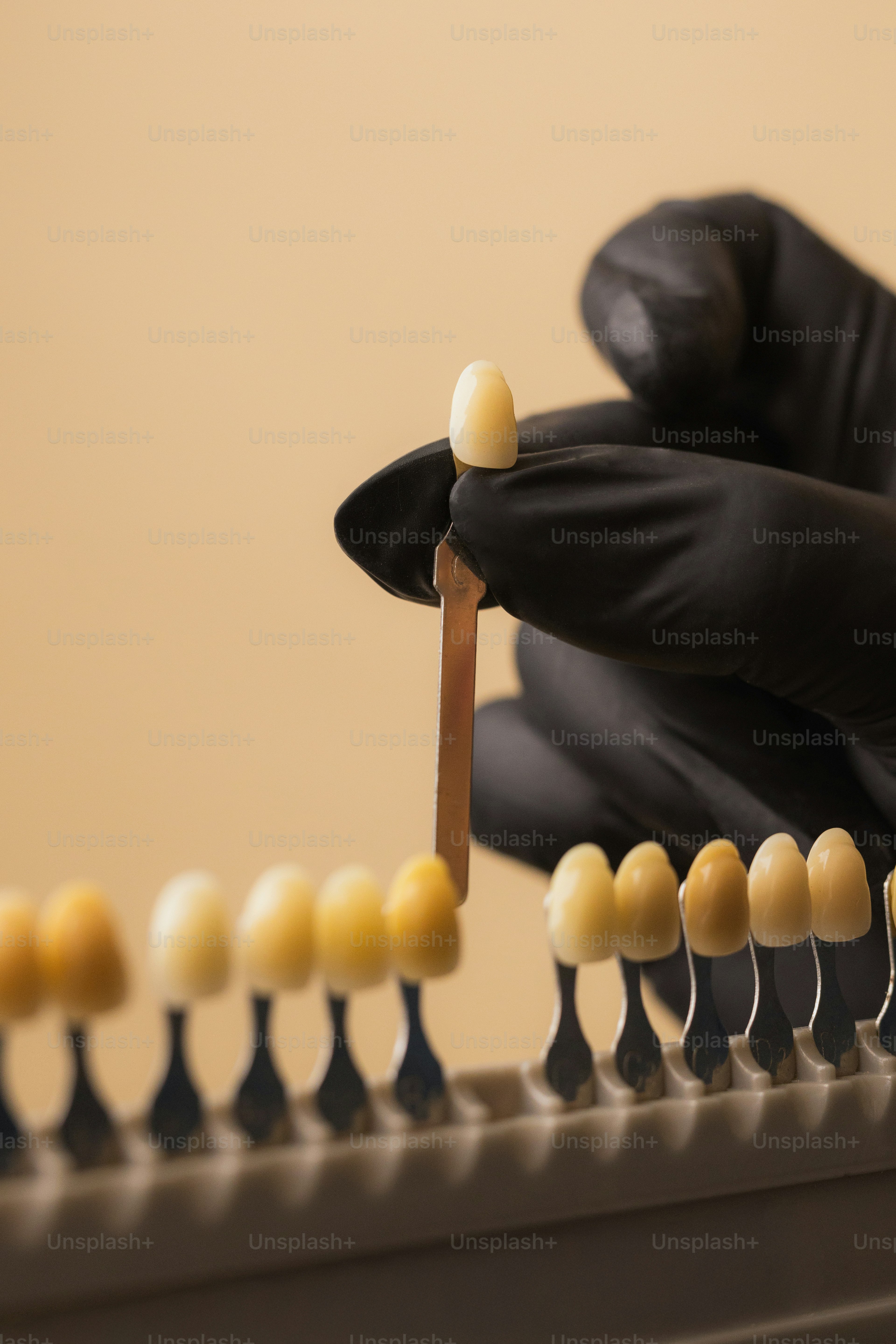 A dentist chooses a tooth color.