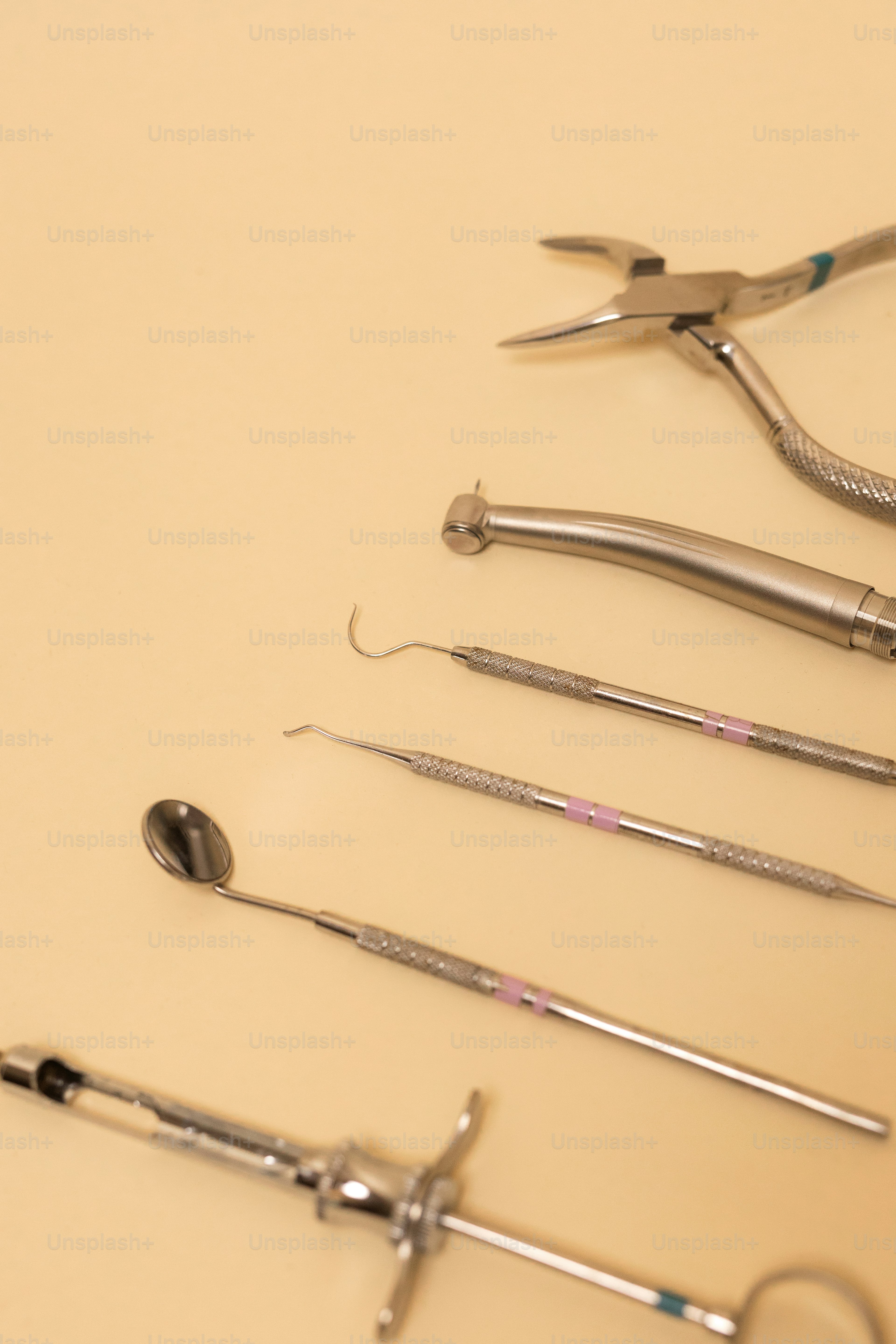 Dental tools are arranged on a neutral surface.