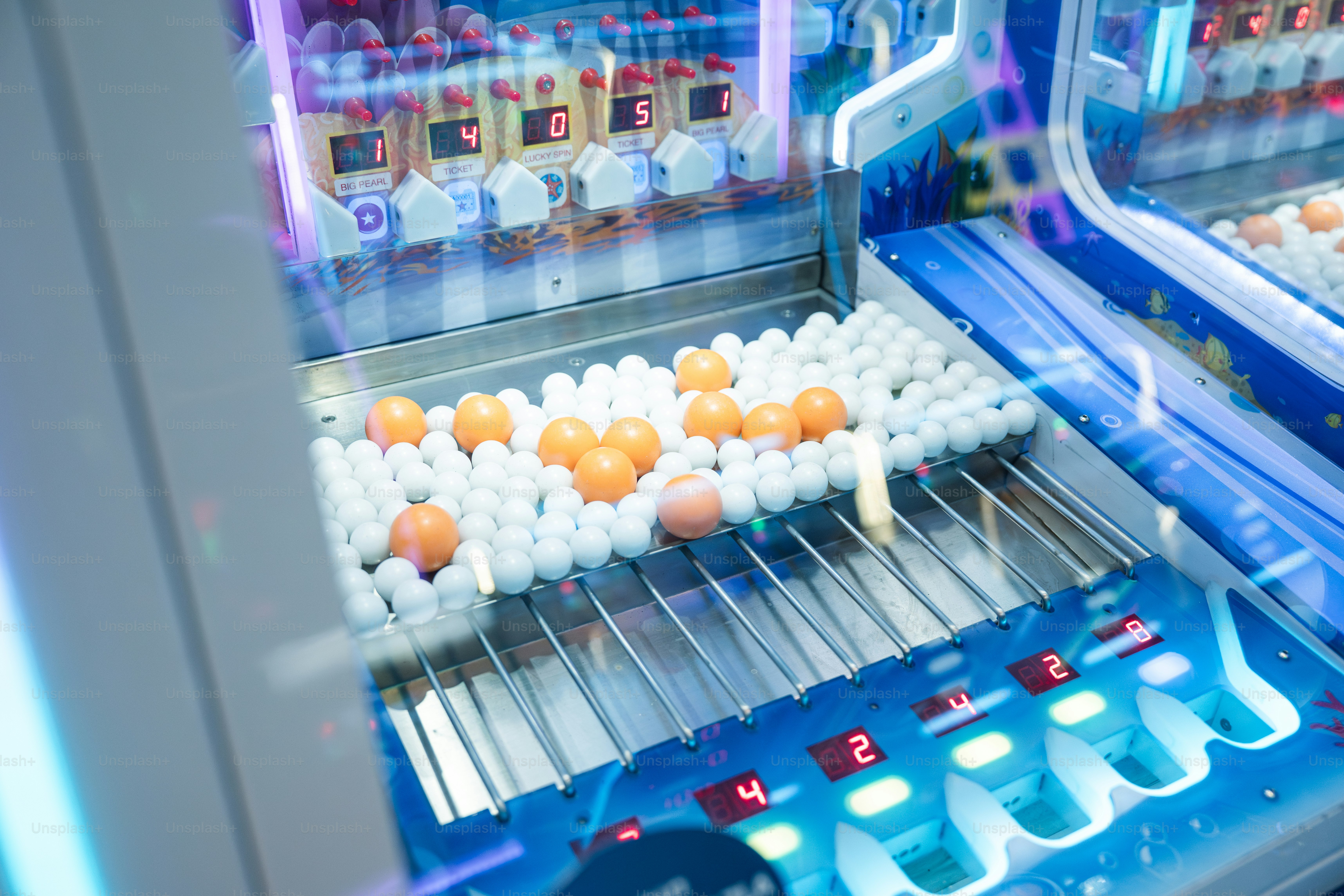 An arcade game machine with colored balls.
