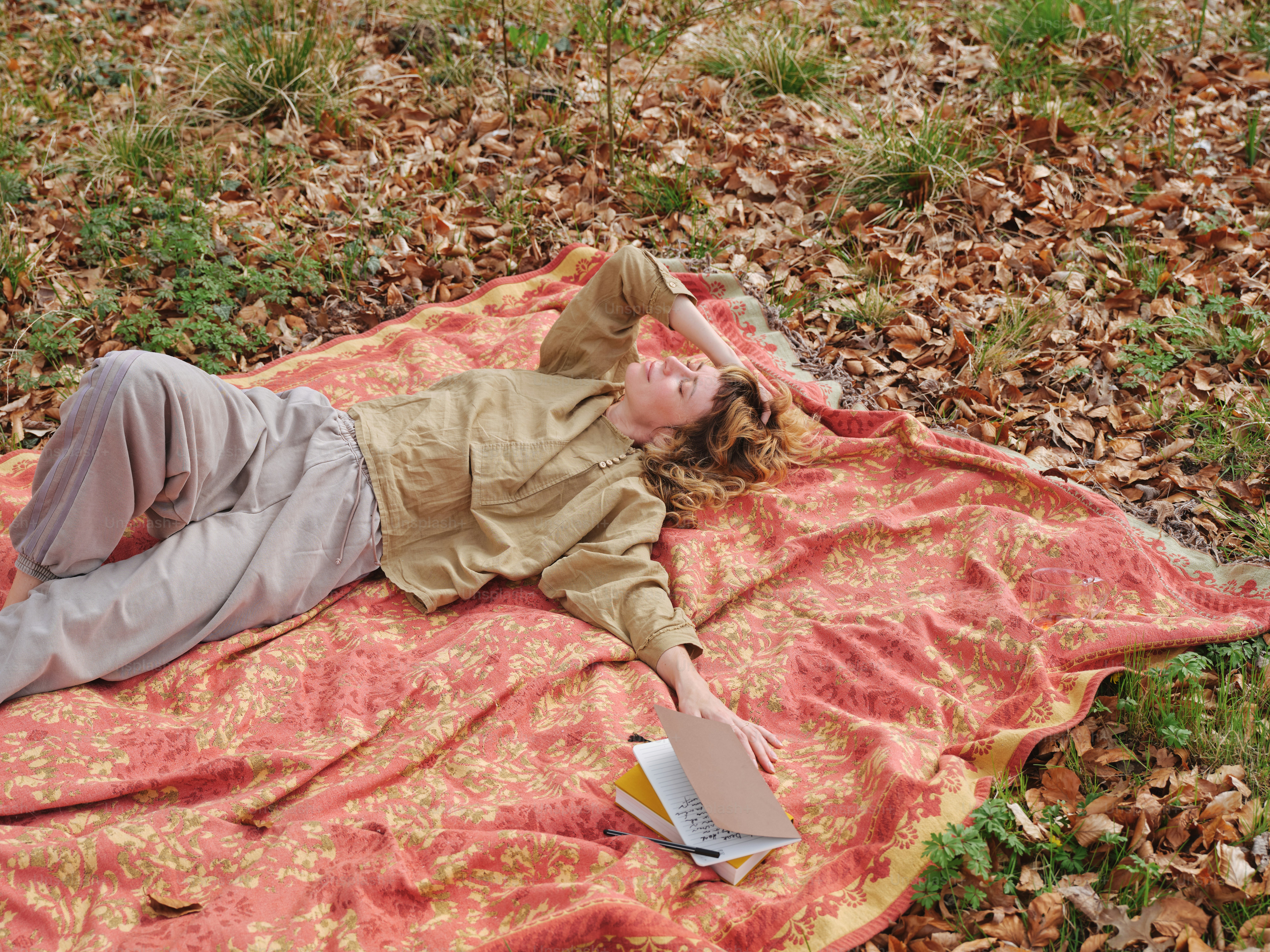 A person reads while relaxing outdoors.