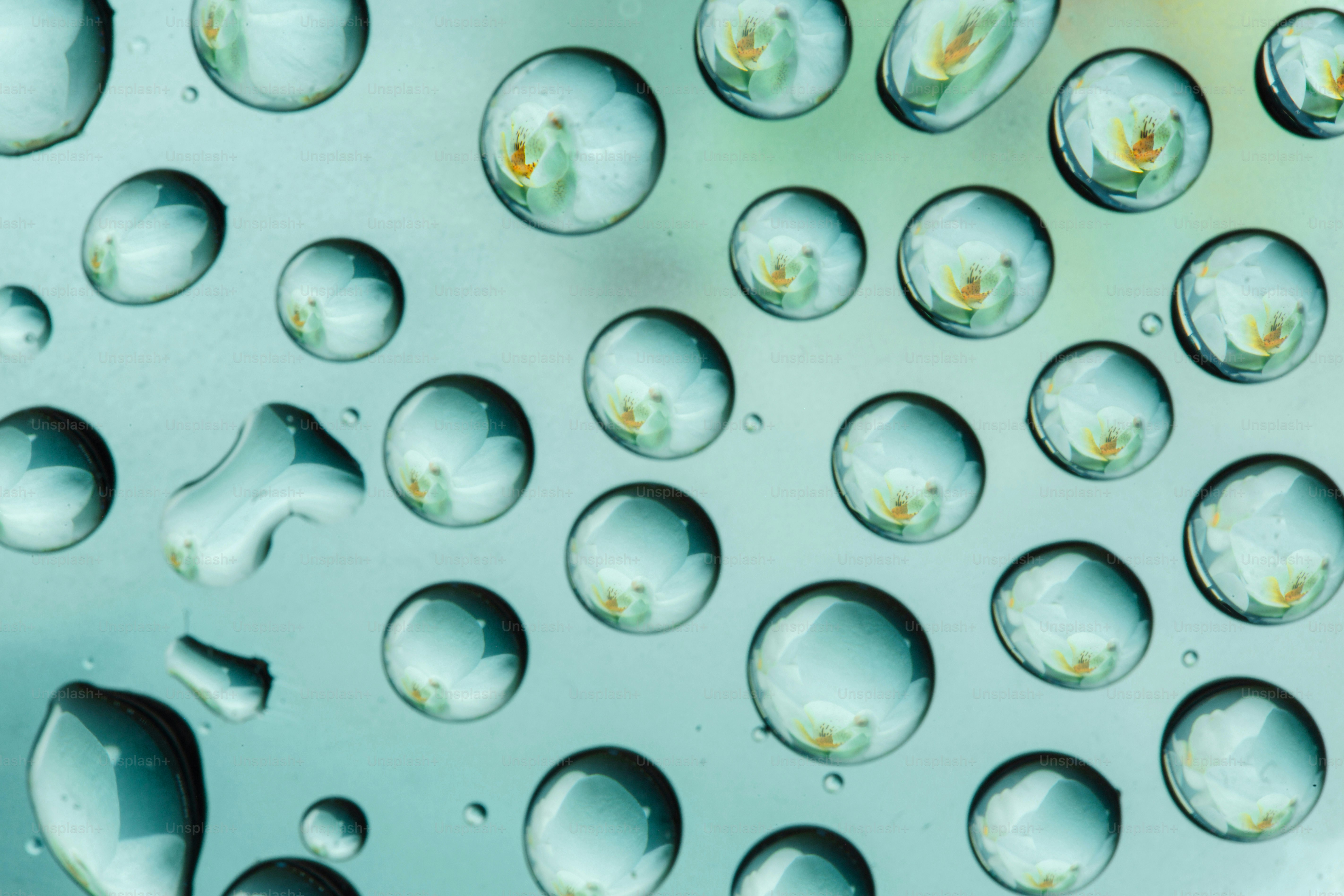 Water droplets reflect light on a surface. photo – Wallpaper Image on ...