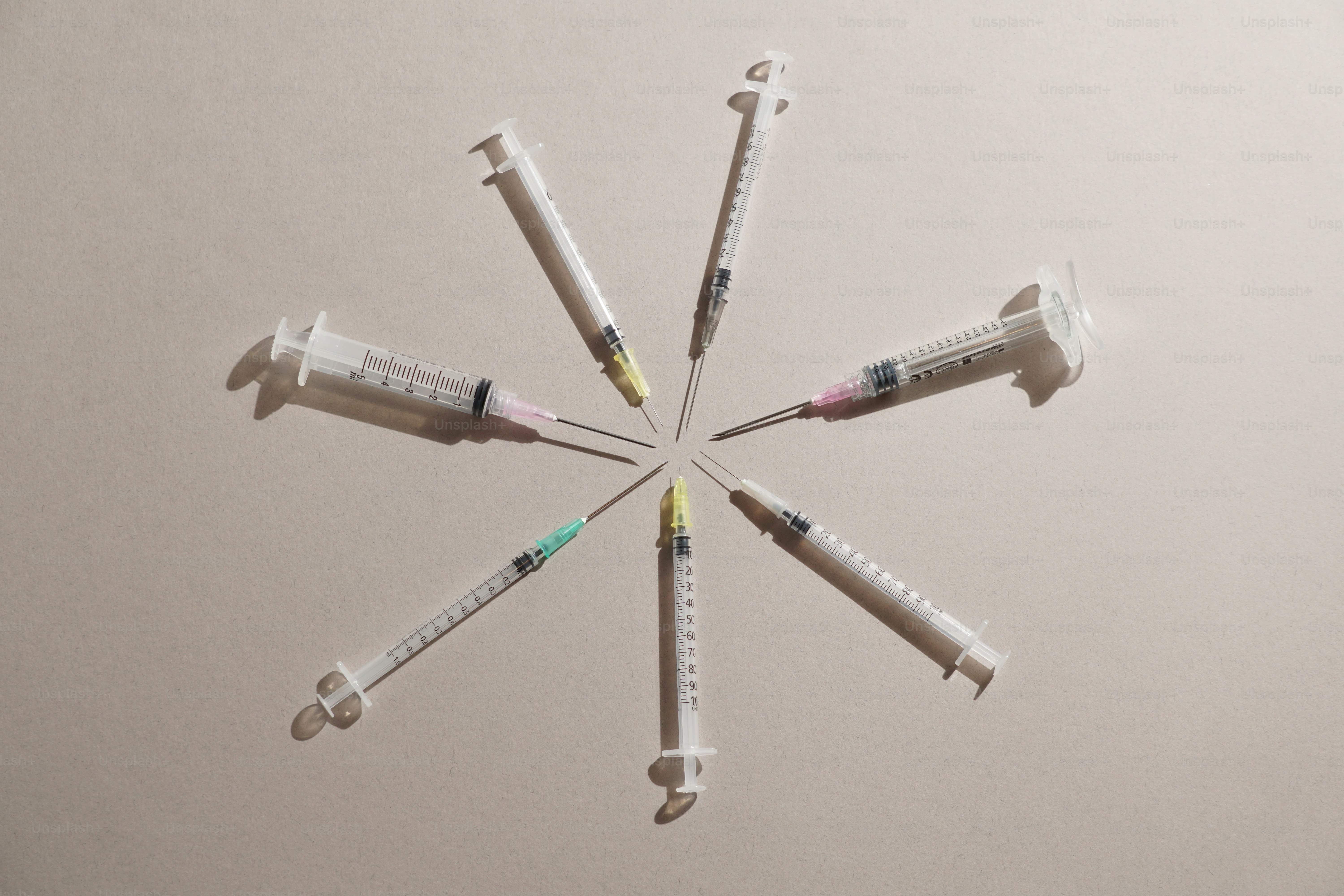 Syringes are arranged in a circular pattern.