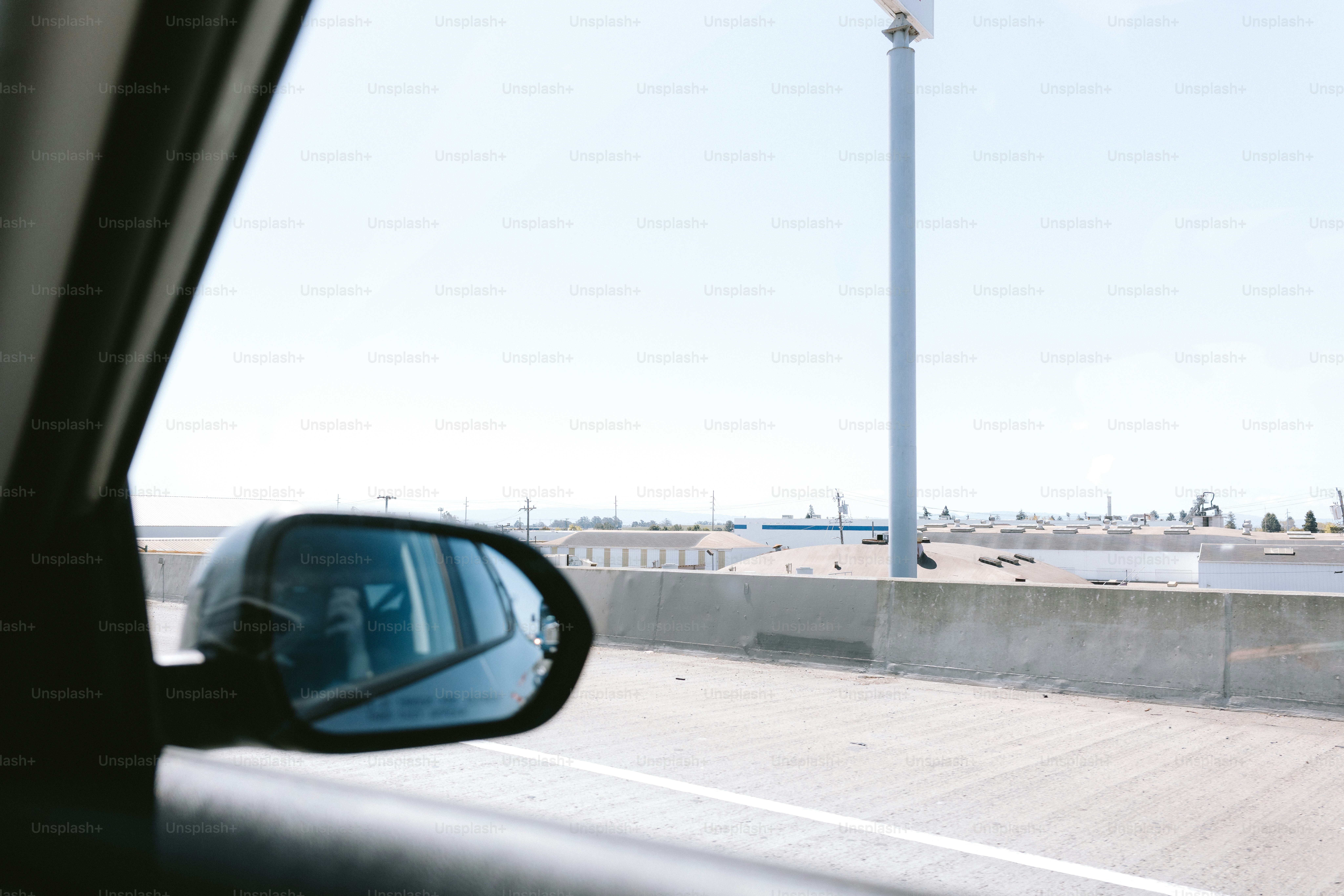 View from a car window, focusing on the side mirror.
