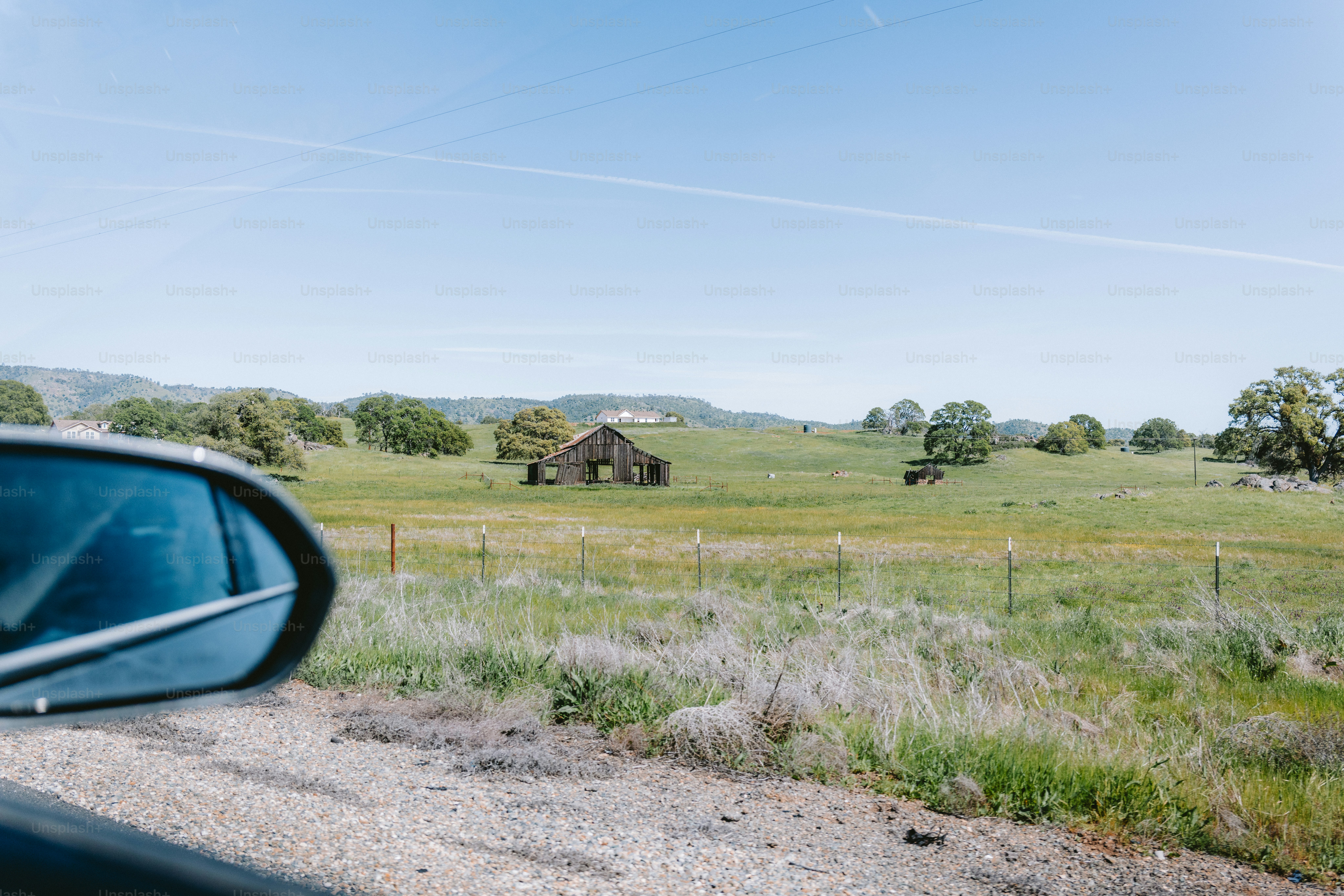 View from a car window of a rural landscape.