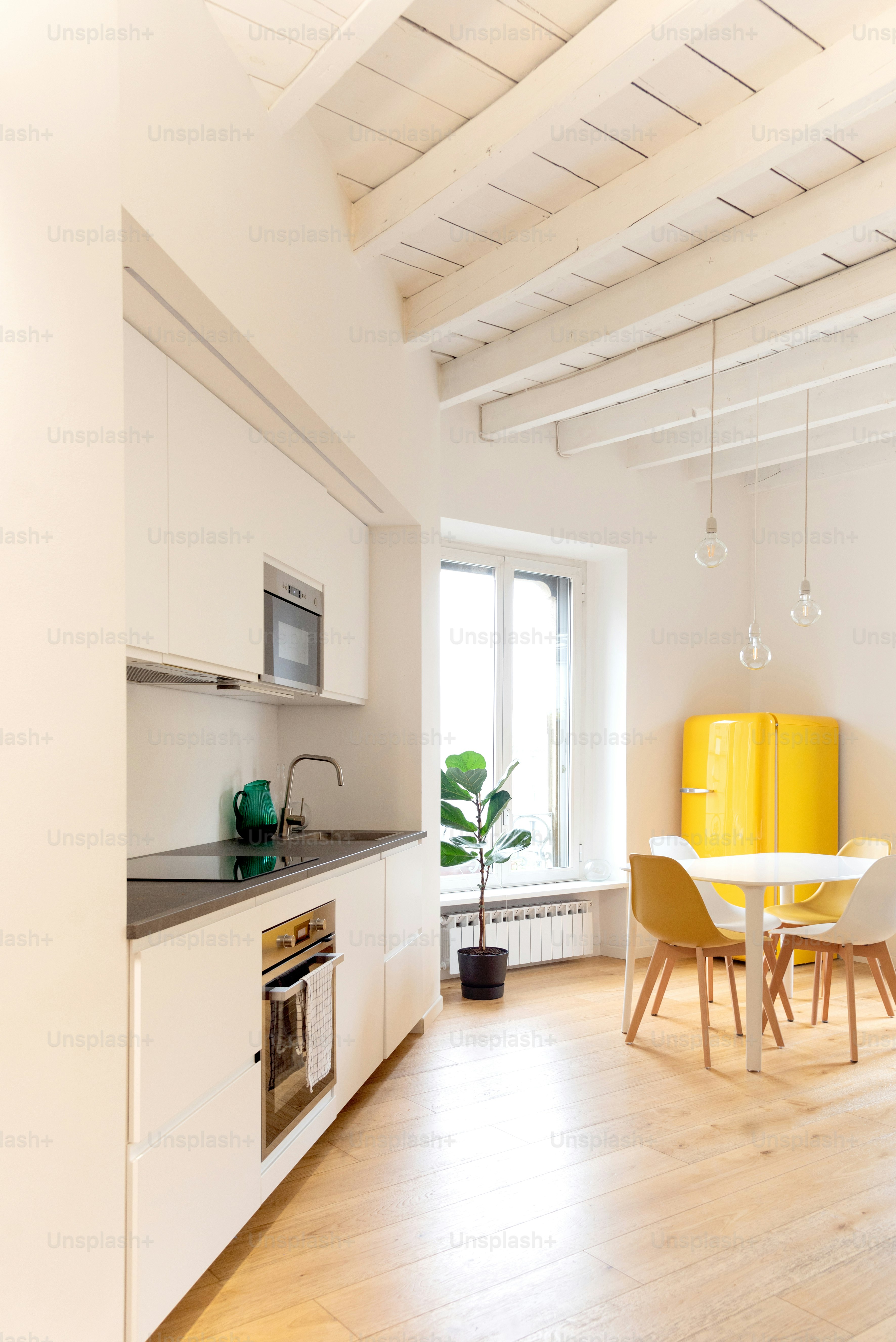 A minimalist kitchen with a dining area. photo – Interior design Image ...
