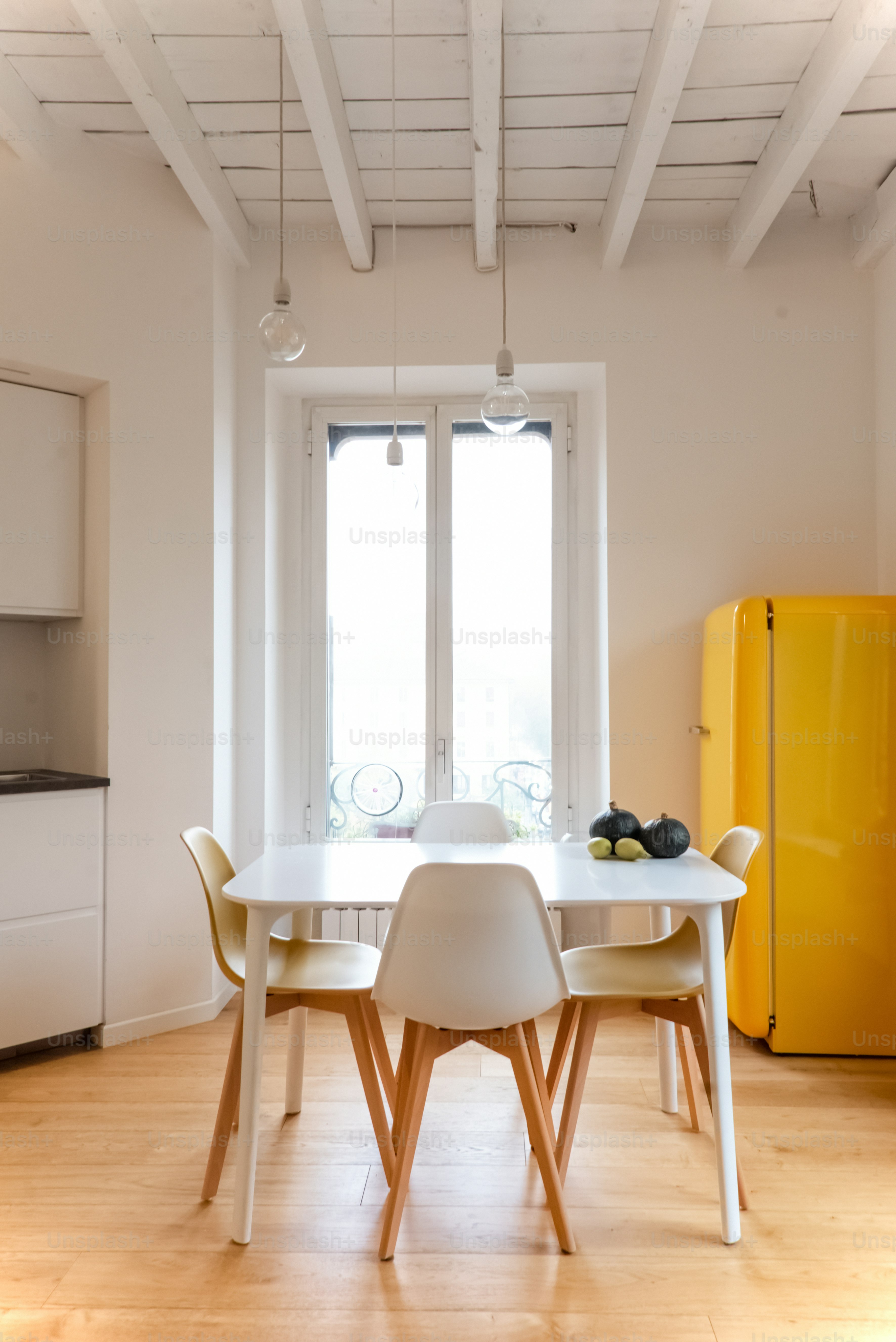 A bright dining room with white and yellow accents. photo – Interior ...