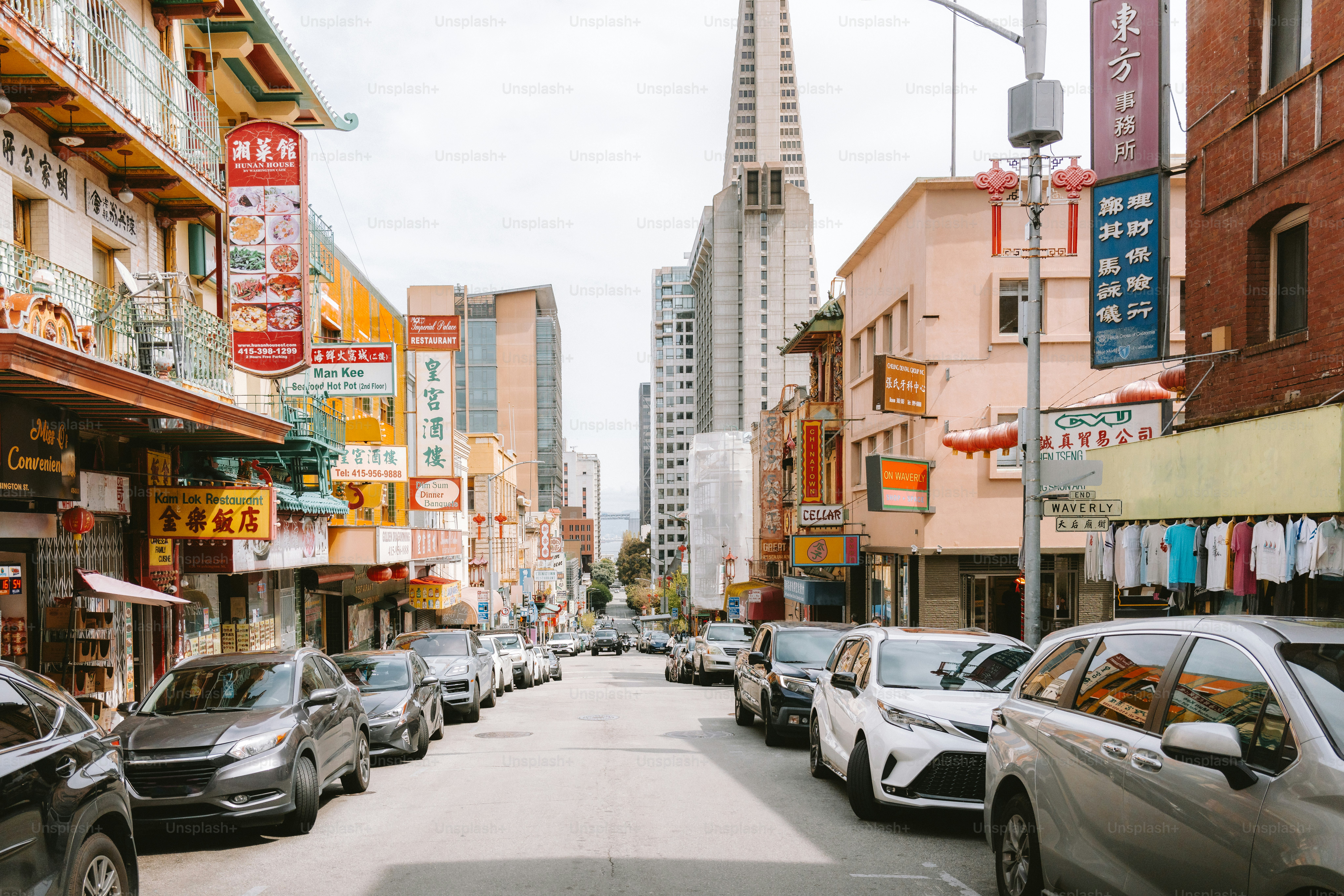 A street in chinatown with cars and buildings.
