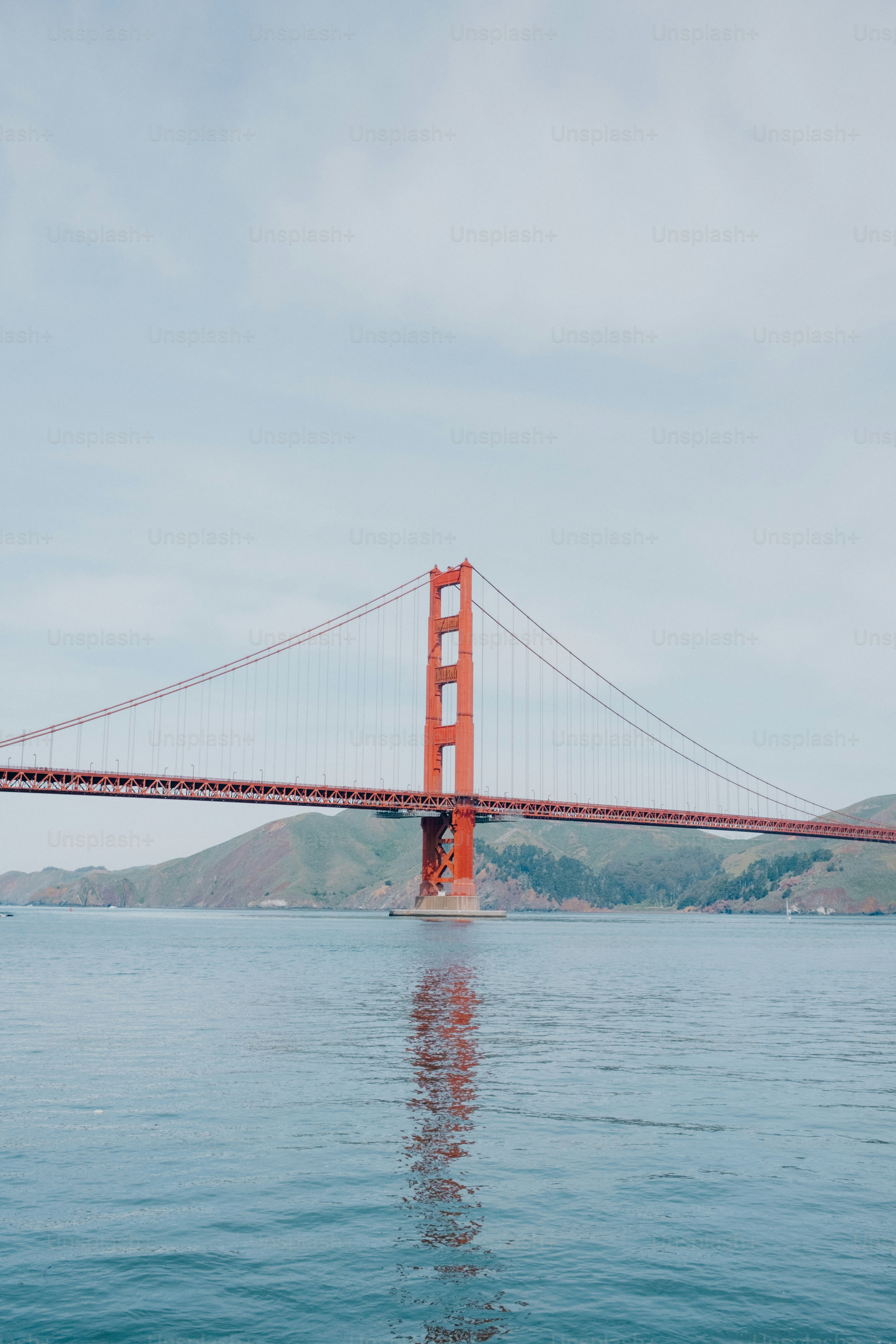 The golden gate bridge stretches across the blue water