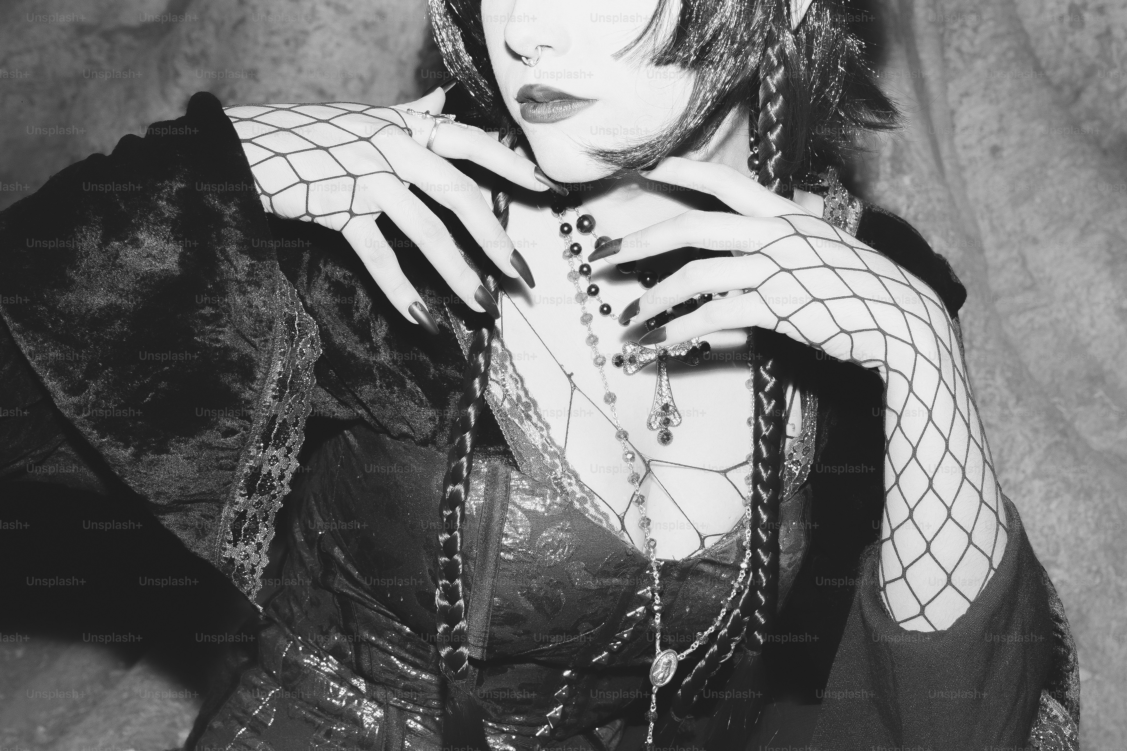 A gothic woman poses in black and white.