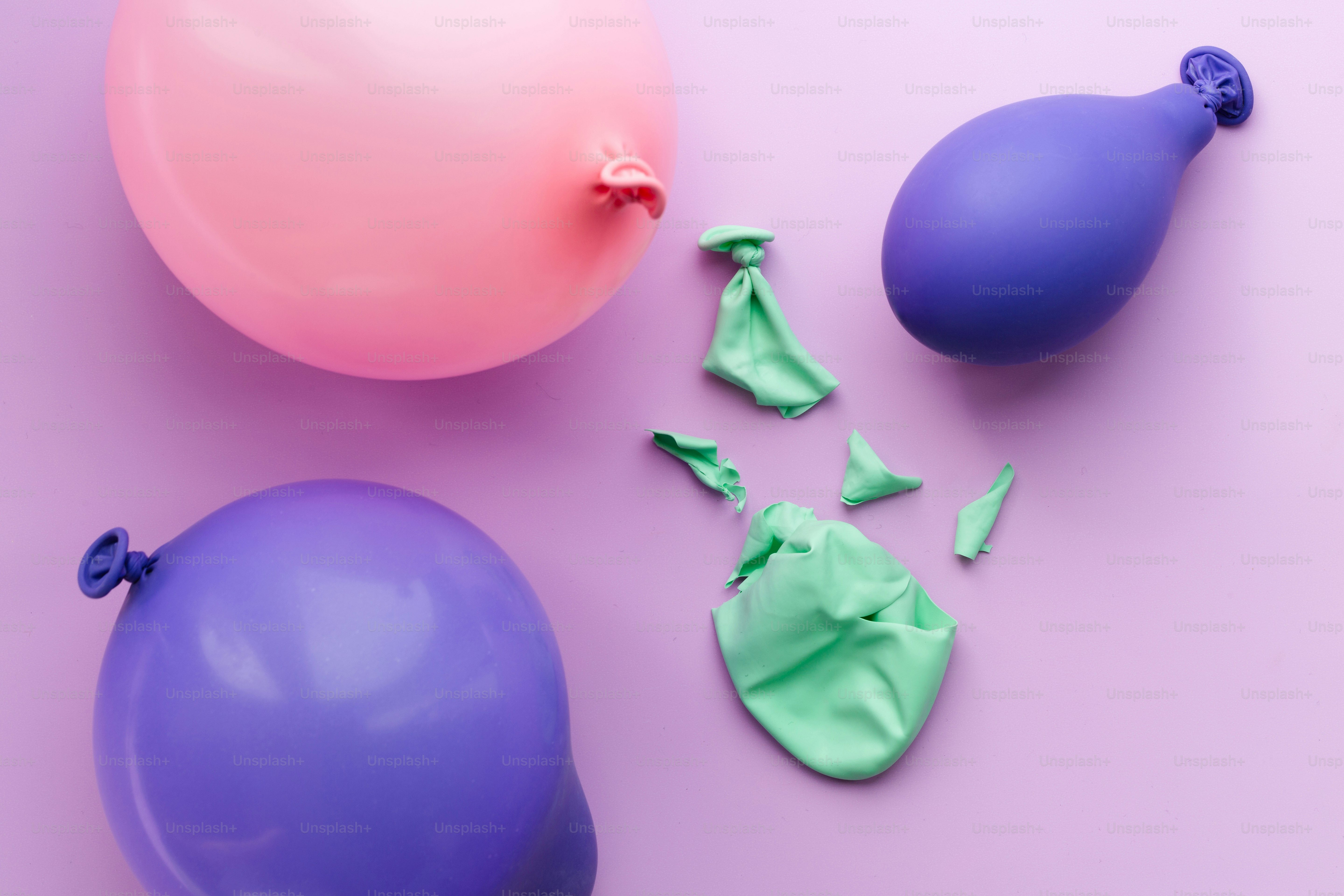 Some balloons are inflated, and one is popped. photo – Blue Image on ...