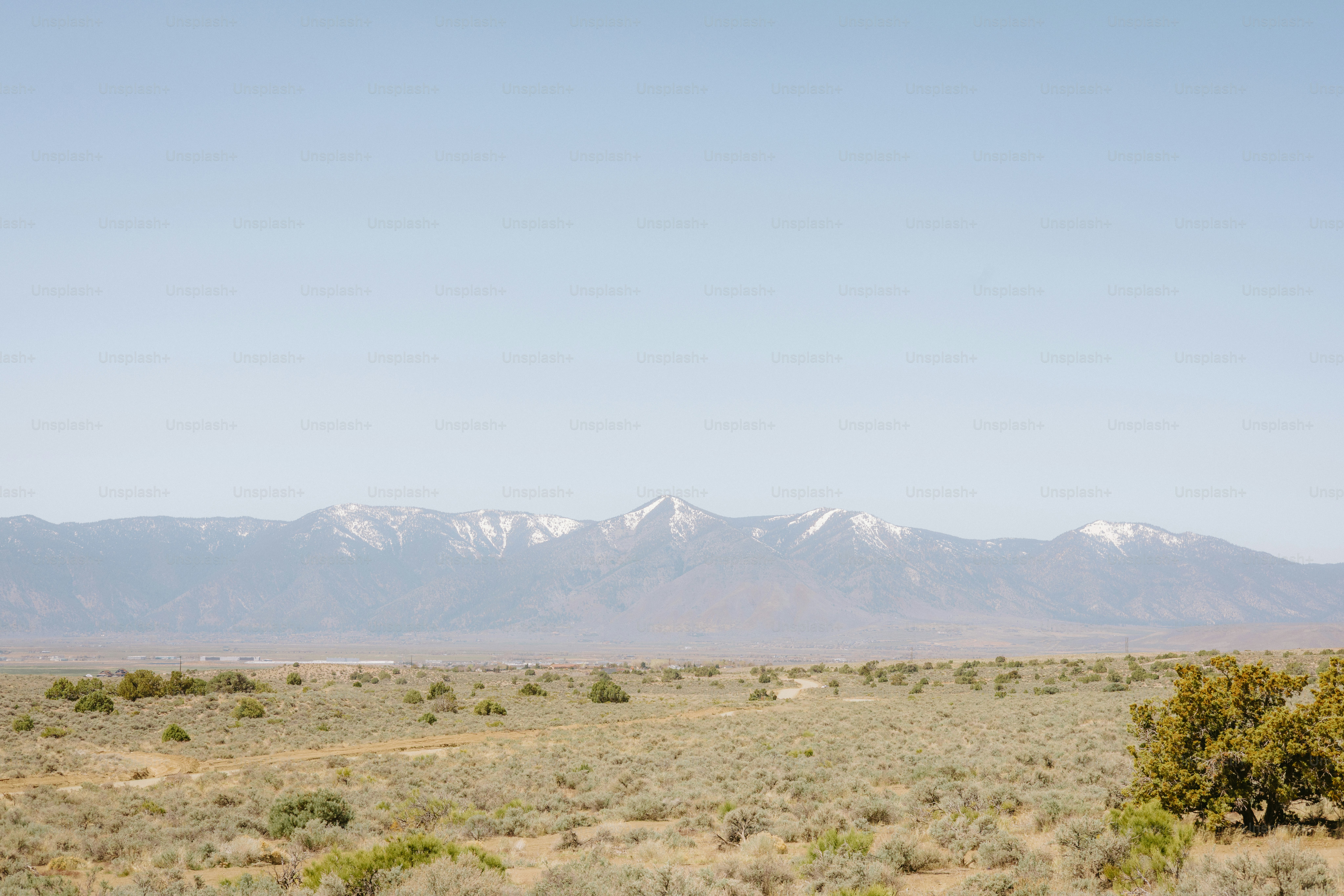 Mountains loom over a vast, arid landscape.