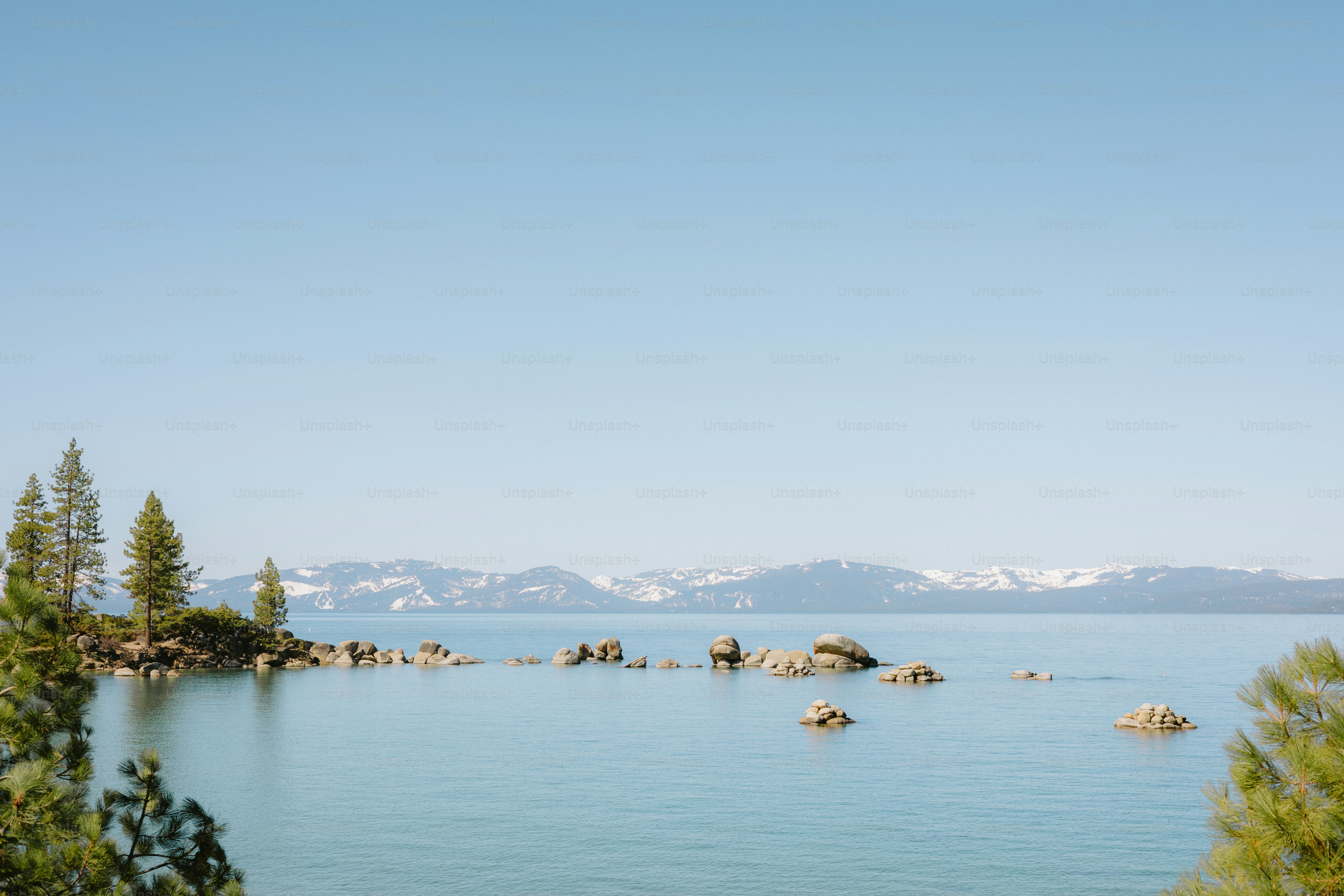 A serene lake scene with mountains in the distance.